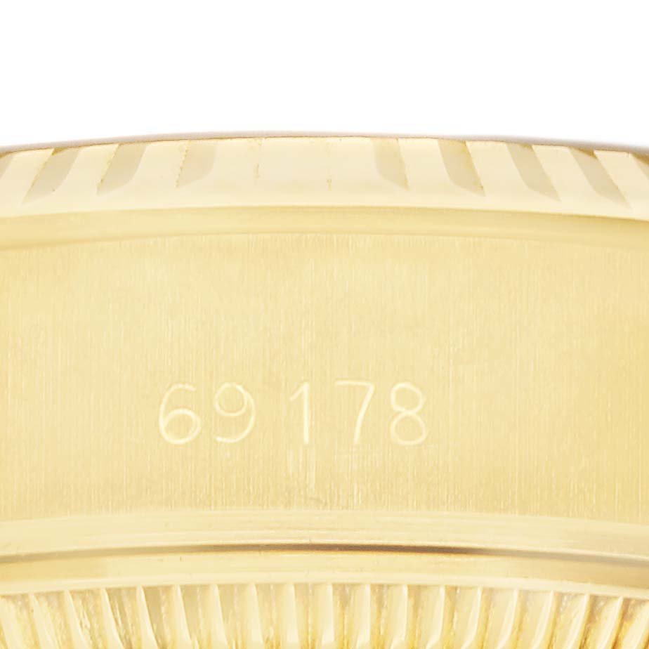 The image shows a close-up of the side of a Rolex President 69178 Women's Yellow Gold White Dial watch case with the model number engraved.