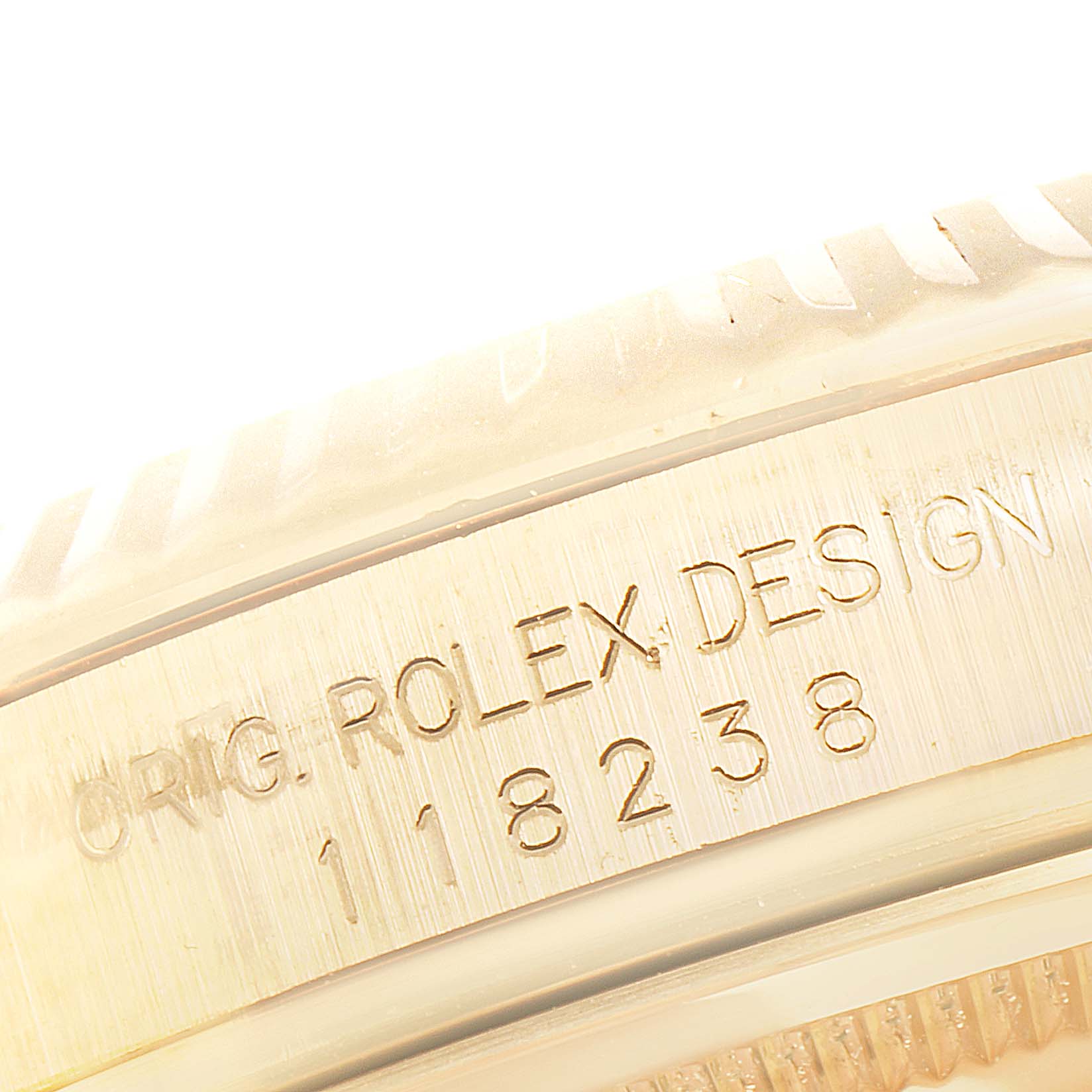 This image shows a close-up of the engraved case side of the Rolex President 118238 Men
s Yellow Gold White Dial 118238 Men
s Yellow Gold White Dial model, detailing the brand and design number.