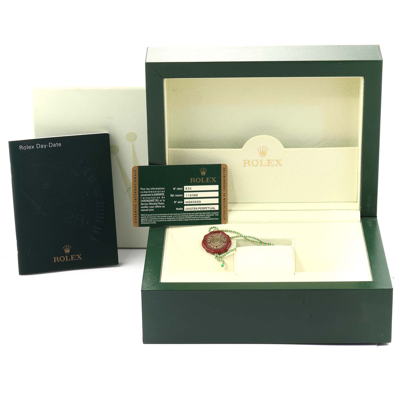 A Rolex President 118388 Men's Yellow Gold Green Dial 118388 Men's Yellow Gold Green Dial model watch box is shown with certification, tag, and instruction booklet, all presented from a front angle.