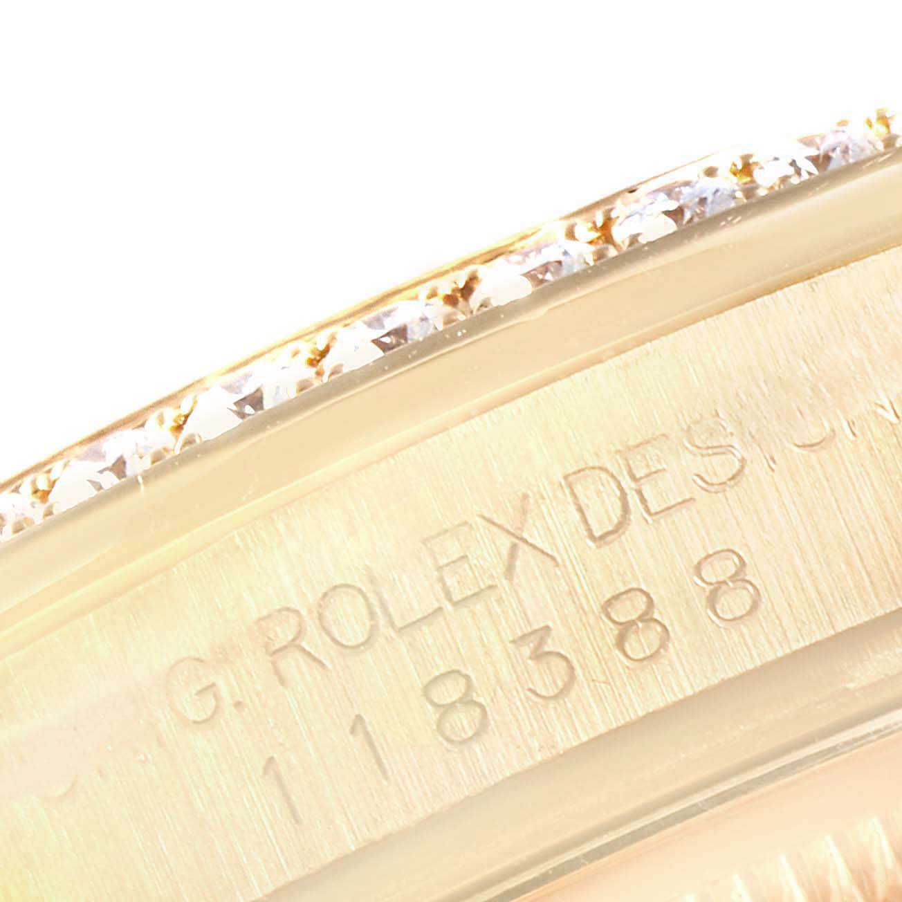 This image shows a close-up of the engraving and diamond-set bezel on a Rolex President 118388 Men's Yellow Gold Green Dial 118388 Men's Yellow Gold Green Dial model watch.
