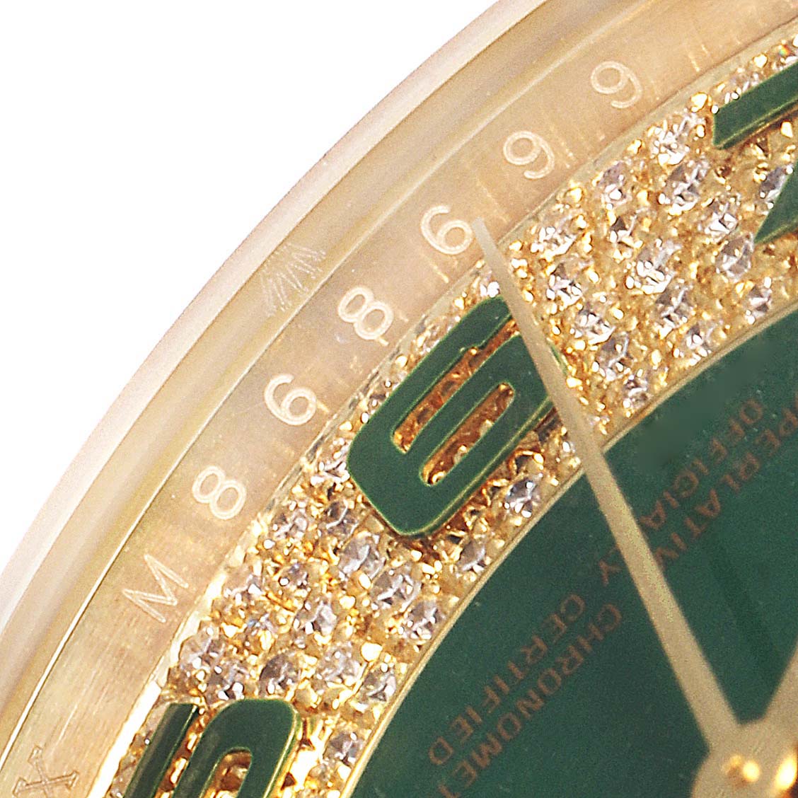This close-up angle of the Rolex President 118388 Men's Yellow Gold Green Dial 118388 Men's Yellow Gold Green Dial watch shows part of the dial with diamond accents and hour markers, including the number 6.