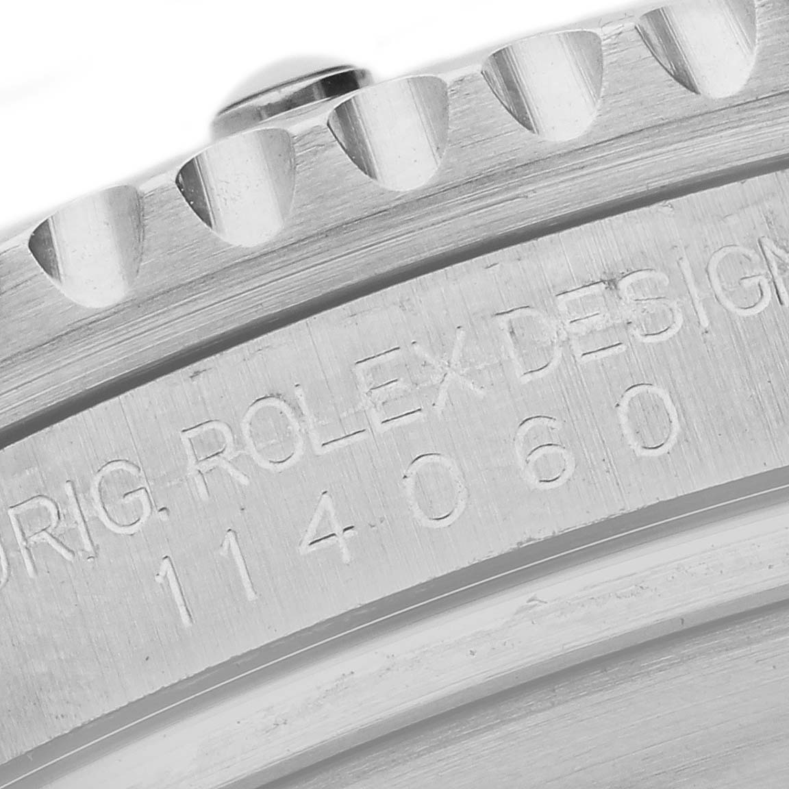 The image shows a close-up of the engraved side of the bezel and case of a Rolex Submariner 114060 Men
s Stainless Steel Black Dial 114060 Men
s Stainless Steel Black Dial watch, highlighting the model number.