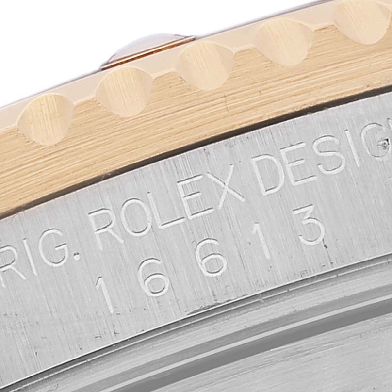 The image shows a close-up of the caseback and the edge of the bezel of a Rolex Submariner 16613 Men's Steel and Gold (two tone) Blue Dial 16613 Men's Steel and Gold (two tone) Blue Dial watch.