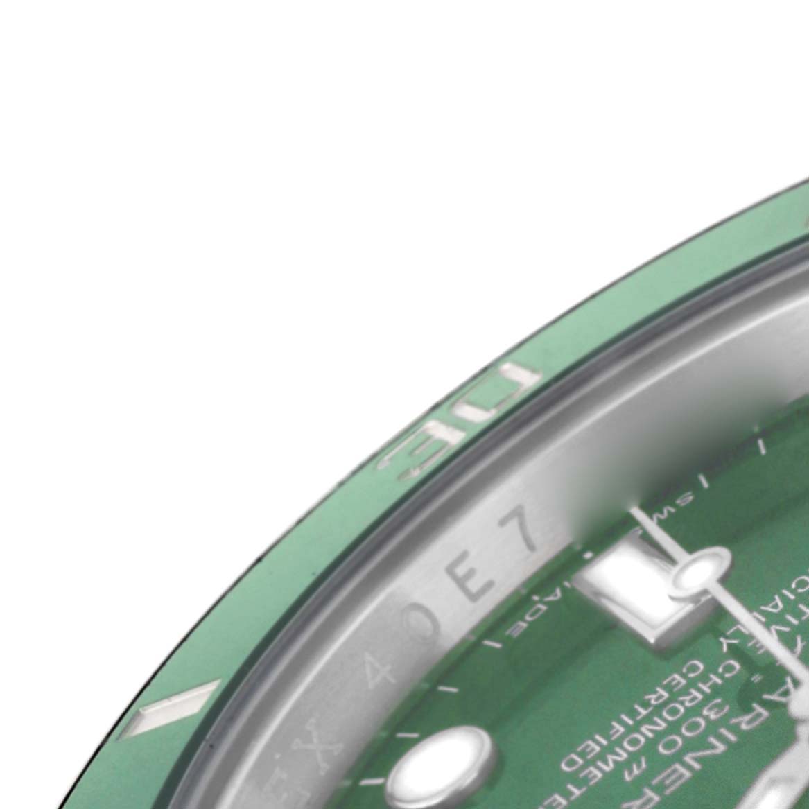 The image shows a close-up, angled view of the Rolex Submariner 116610LV Men's Stainless Steel Green Dial's dial and part of the bezel, focusing on the markers and a hand.