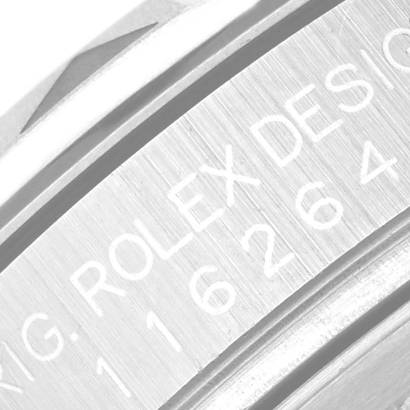 This close-up image shows the engraved bevel and part of the bezel of a Rolex Turn-o-Graph 116264 Men's Stainless Steel White Dial 116264 Men's Stainless Steel White Dial watch.