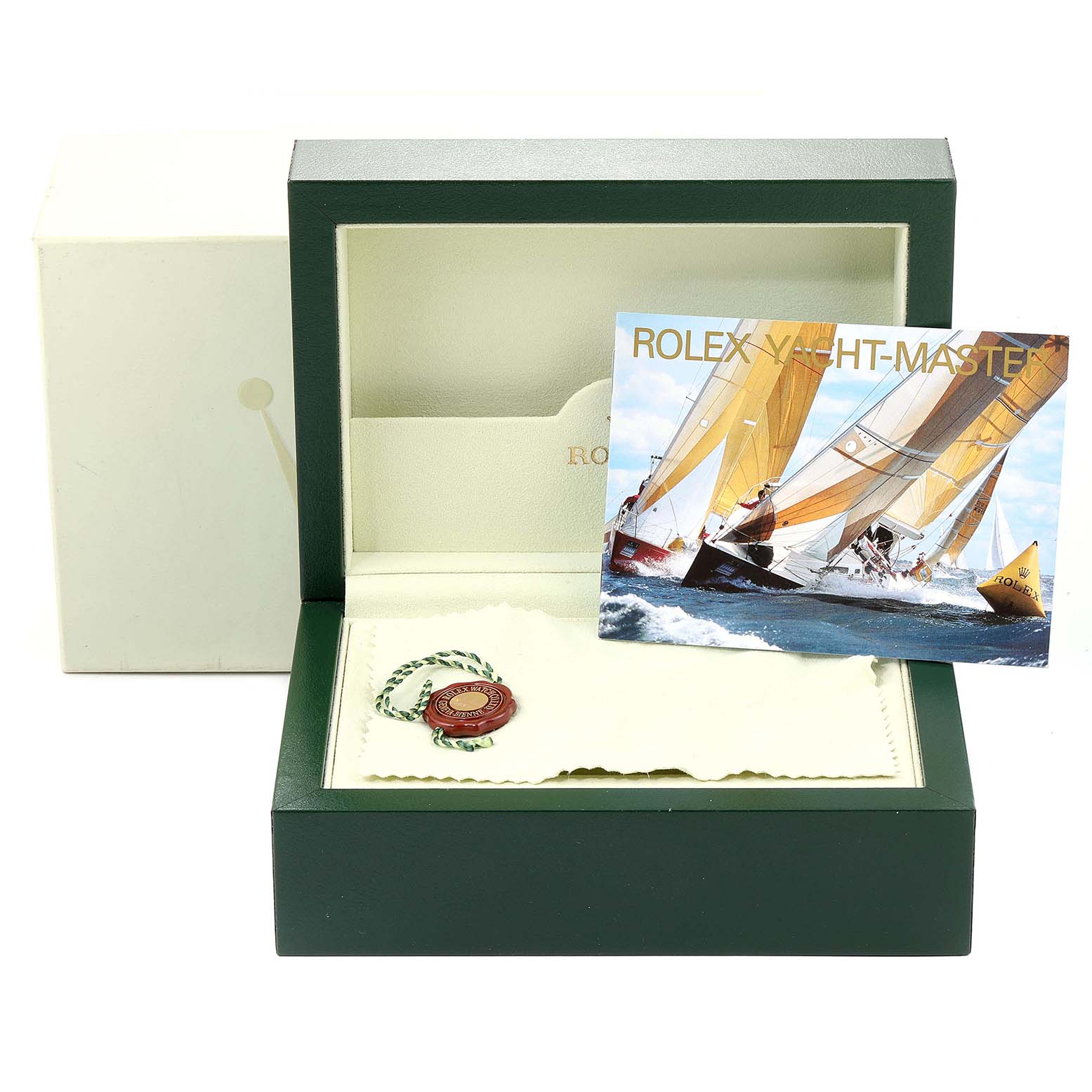 The image shows the Yacht-Master Rolex box, a manual, cloth, and a hang tag from an eye-level perspective.