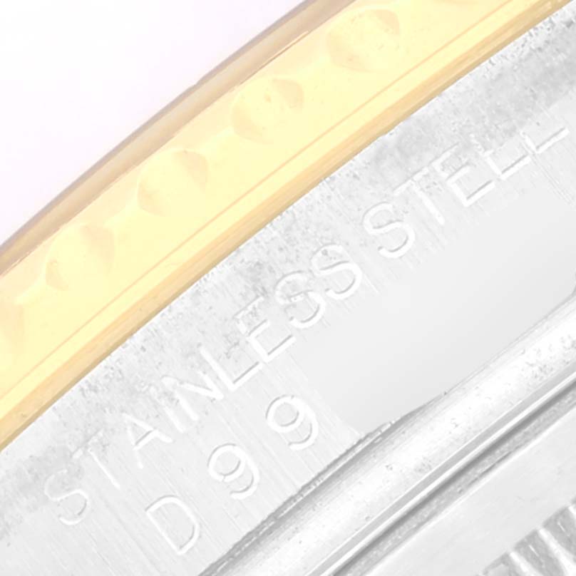 This close-up of the Rolex Yacht-Master 16623 Men
s Steel and Gold (two tone) White Dial 16623 Men
s Steel and Gold (two tone) White Dial watch shows the edge of the bezel and part of the stainless steel case.