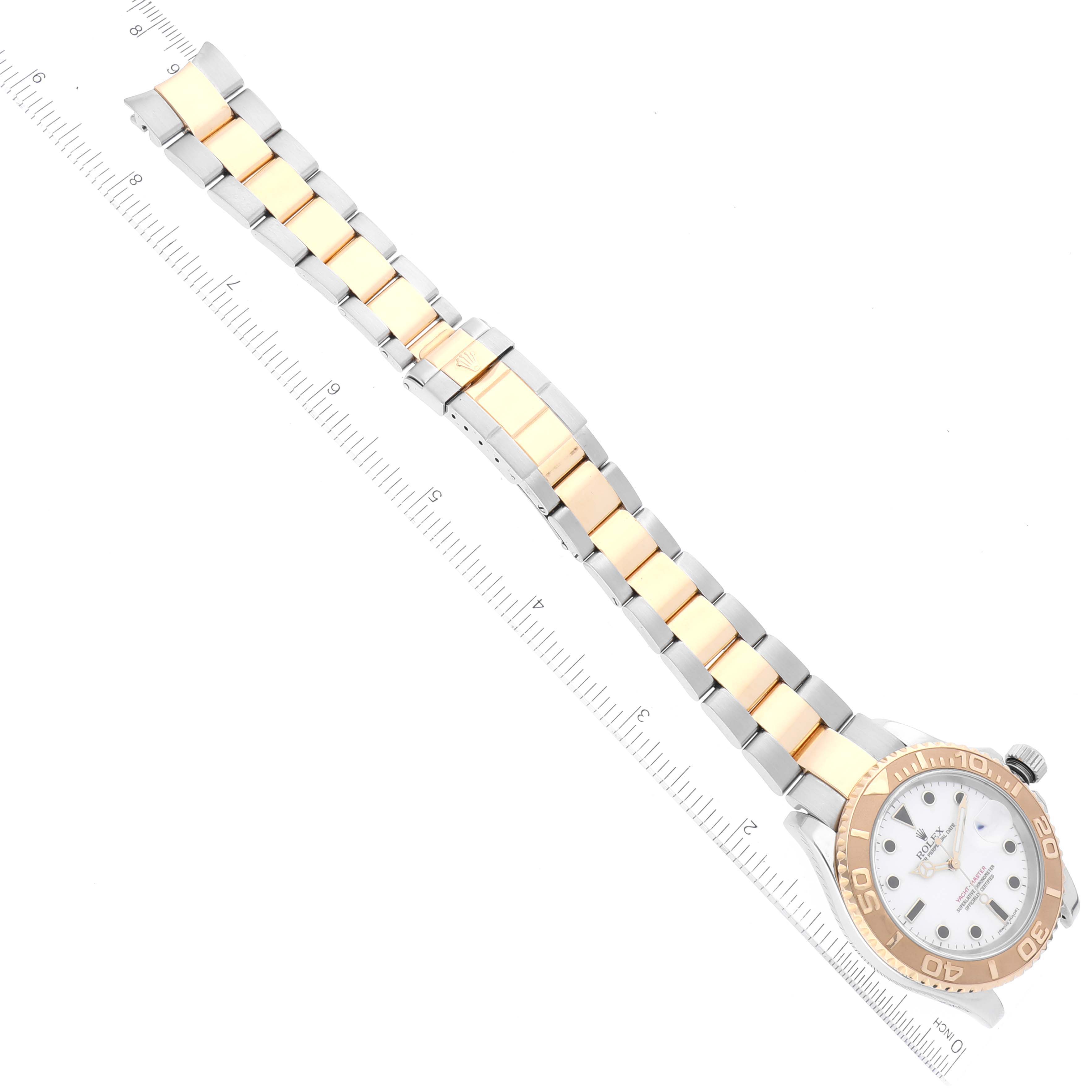 The image shows a Rolex Yacht-Master 16623 Men
s Steel and Gold (two tone) White Dial 16623 Men
s Steel and Gold (two tone) White Dial watch from an overhead angle, with a focus on its two-tone bracelet and bezel.