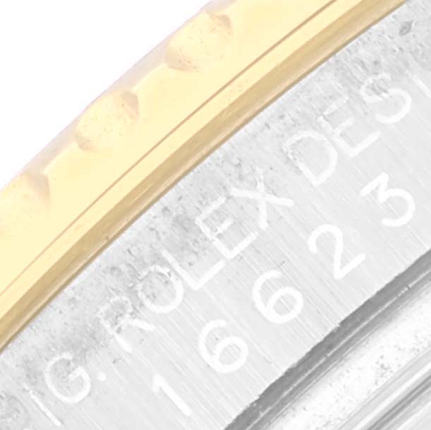 The image shows a close-up of the engraved bezel and case side of the Rolex Yacht-Master 16623 Men
s Steel and Gold (two tone) White Dial 16623 Men
s Steel and Gold (two tone) White Dial watch.