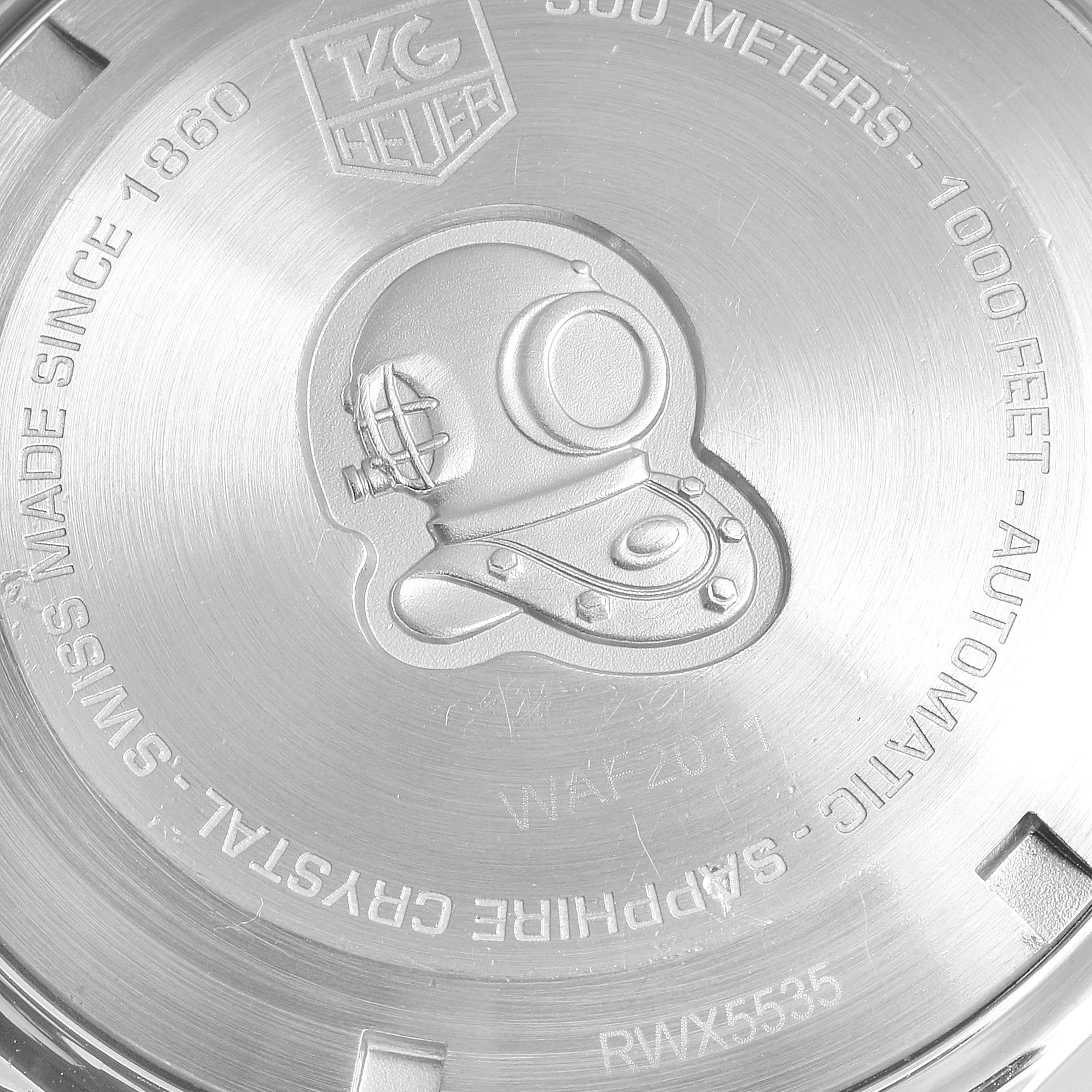 This image shows the engraved case back of a Tag Heuer Aquaracer WAF2011.BA0818 Men's Stainless Steel Silver Dial WAF2011.BA0818 Men's Stainless Steel Silver Dial watch with detailed text and a diver's helmet.