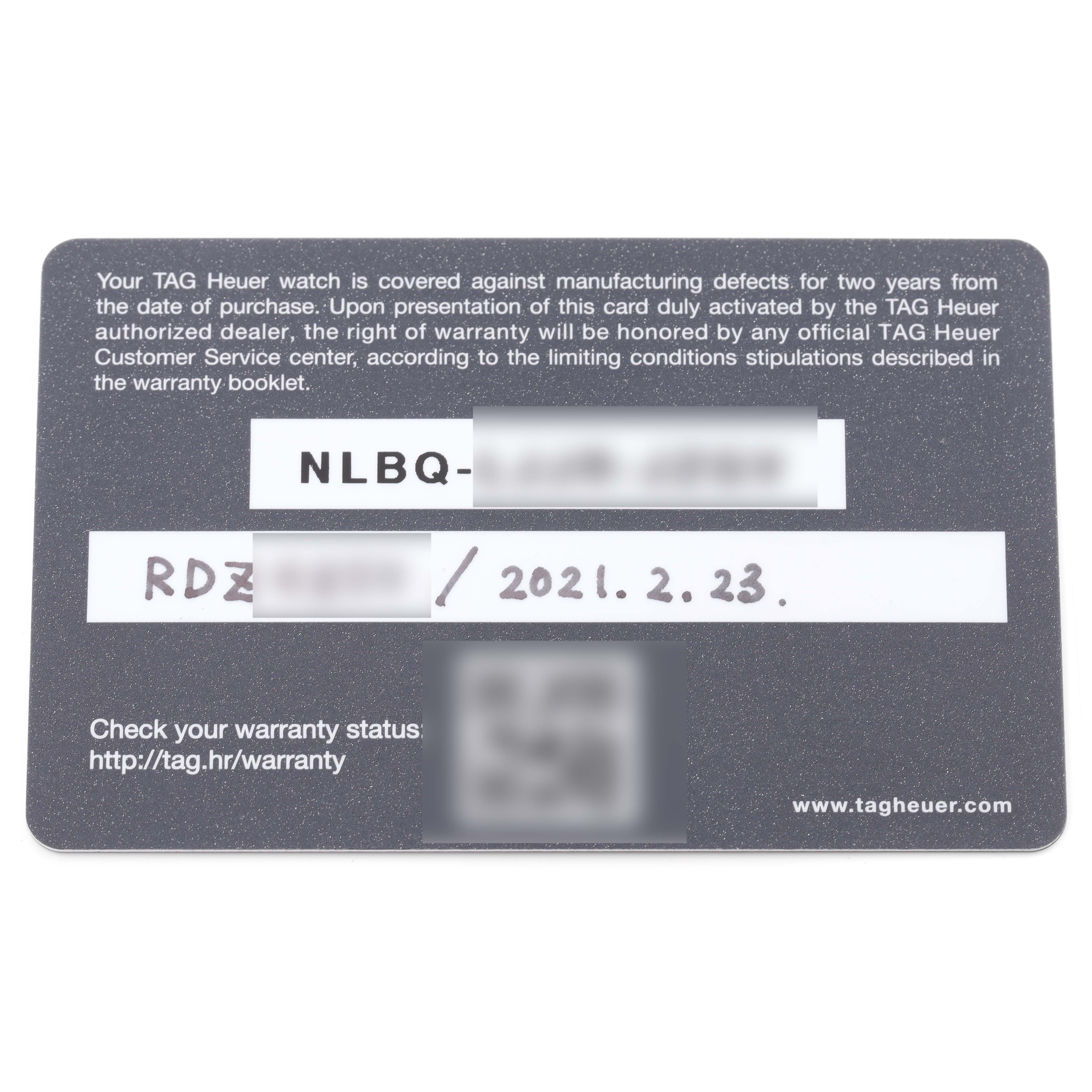 This image shows a Tag Heuer warranty card for the Carrera model, captured from a top-down angle.