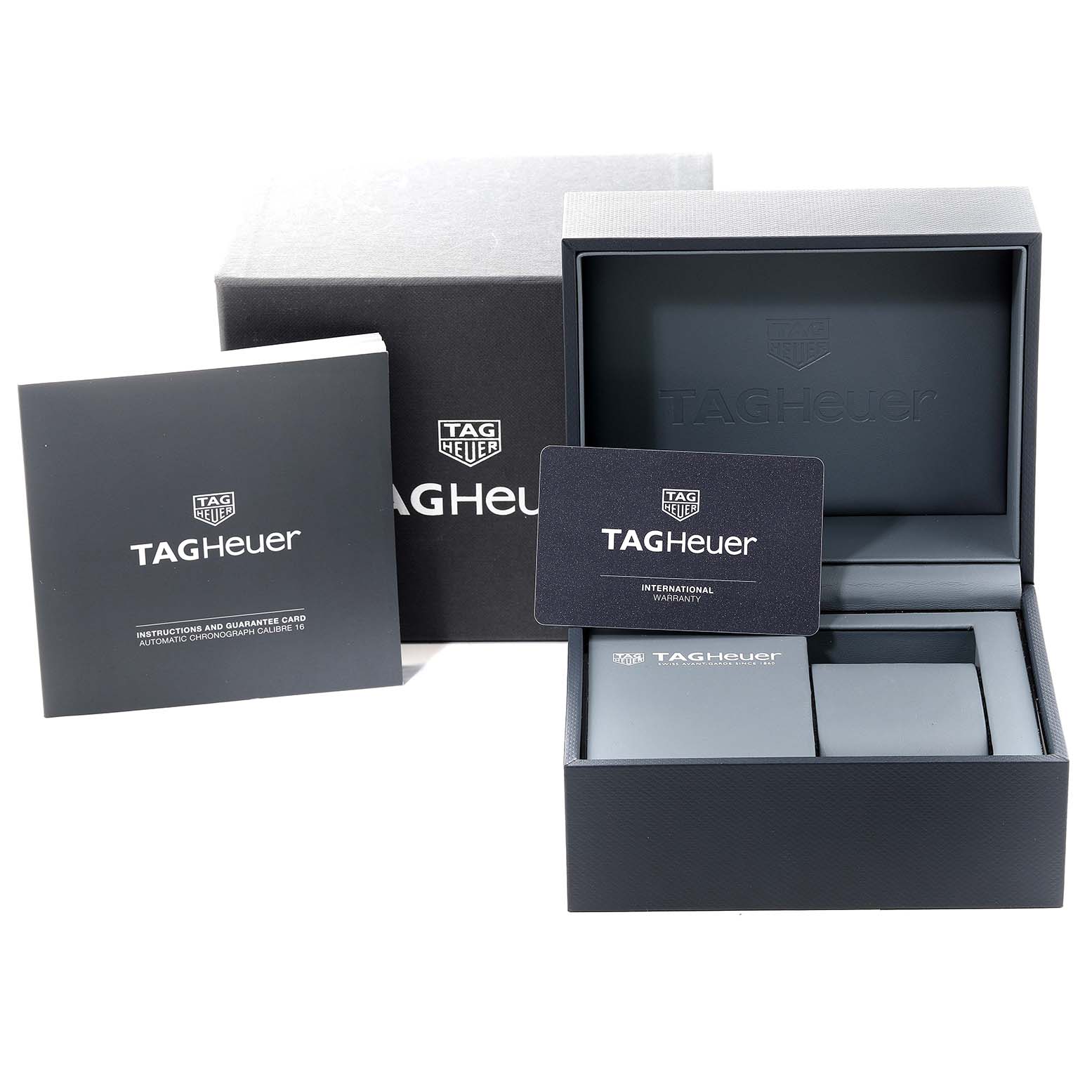 The image shows the packaging and accessories for a Tag Heuer Carrera CBM2112.BA0651 Men's Stainless Steel Blue Dial CBM2112.BA0651 Men's Stainless Steel Blue Dial watch, including the box, warranty card, and instruction booklet.