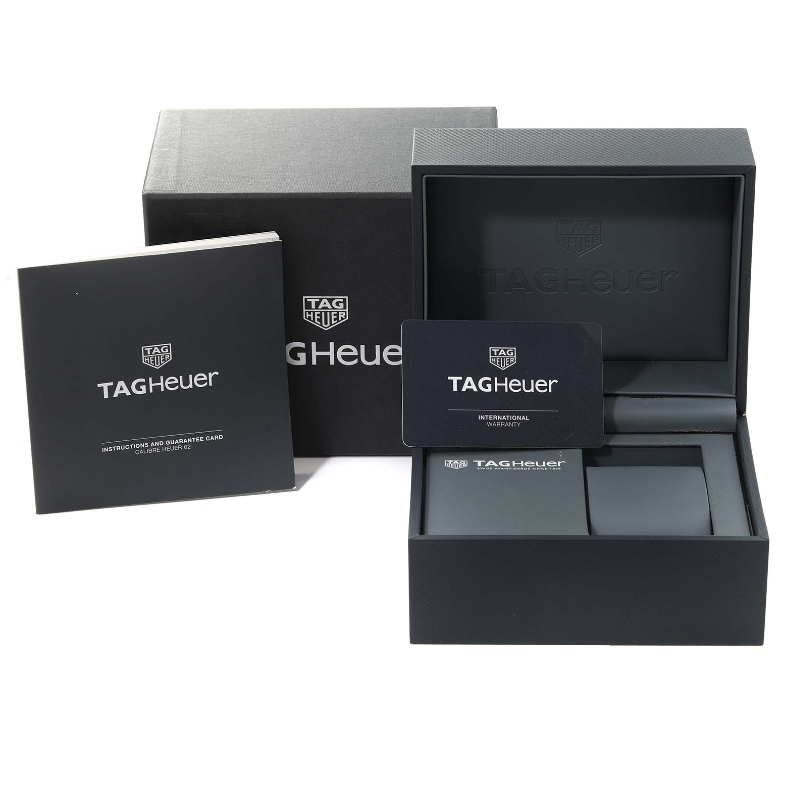 The image shows the packaging and accessories for the Tag Heuer Carrera CBG2A90.BH0653 Men's Stainless Steel Black Dial CBG2A90.BH0653 Men's Stainless Steel Black Dial watch, including the box, manual, and warranty card.