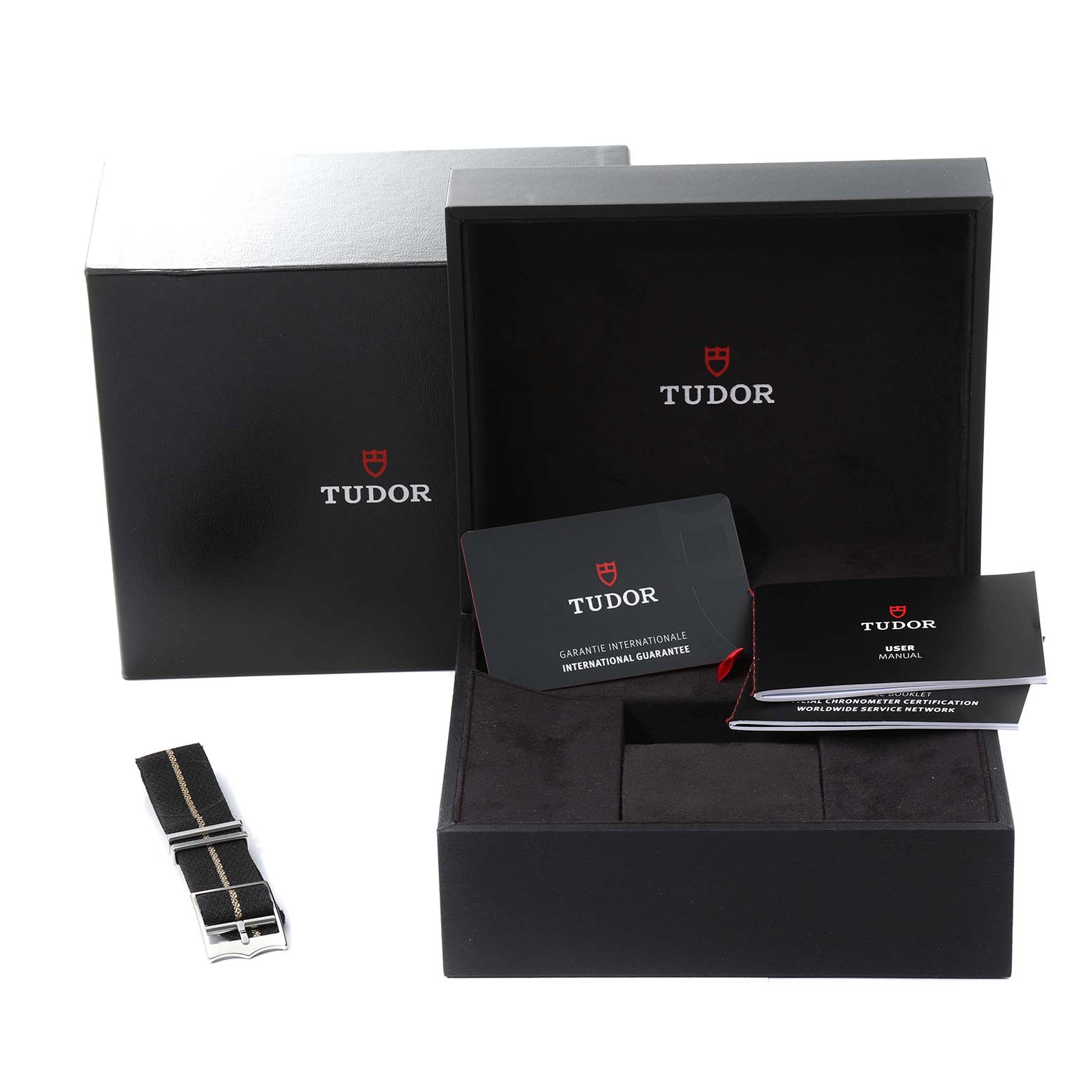 This image shows the Tudor Heritage Black Bay 79030N Men's Stainless Steel Black Dial 79030N Men's Stainless Steel Black Dial watch box, warranty card, user manual, and a spare strap.