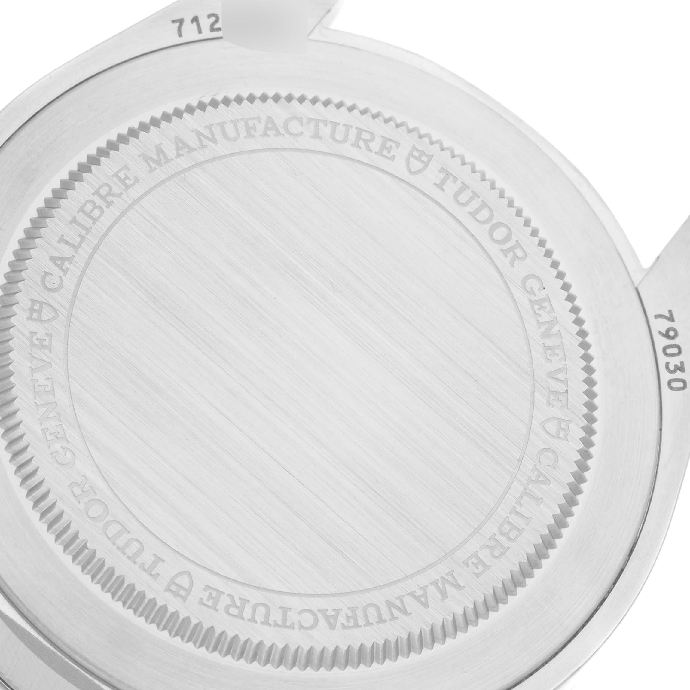 The image shows the case back of a Heritage Black Bay watch by Tudor, displaying engravings and part of the lugs.