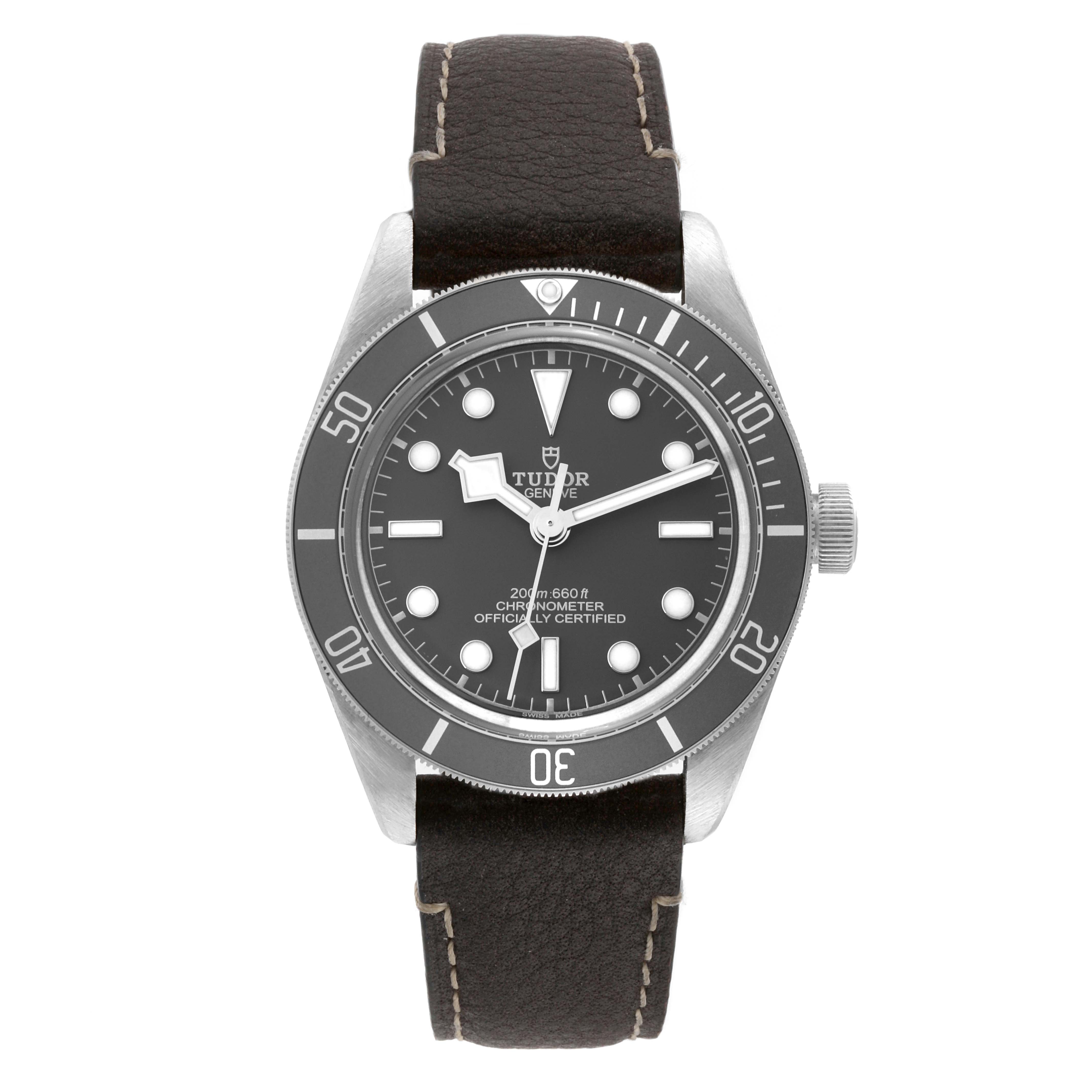 This image shows a front view of the Tudor Heritage Black Bay M79010SG-0002 Men's Stainless Steel Grey Dial M79010SG-0002 Men's Stainless Steel Grey Dial watch with a black dial and a dark brown leather strap.