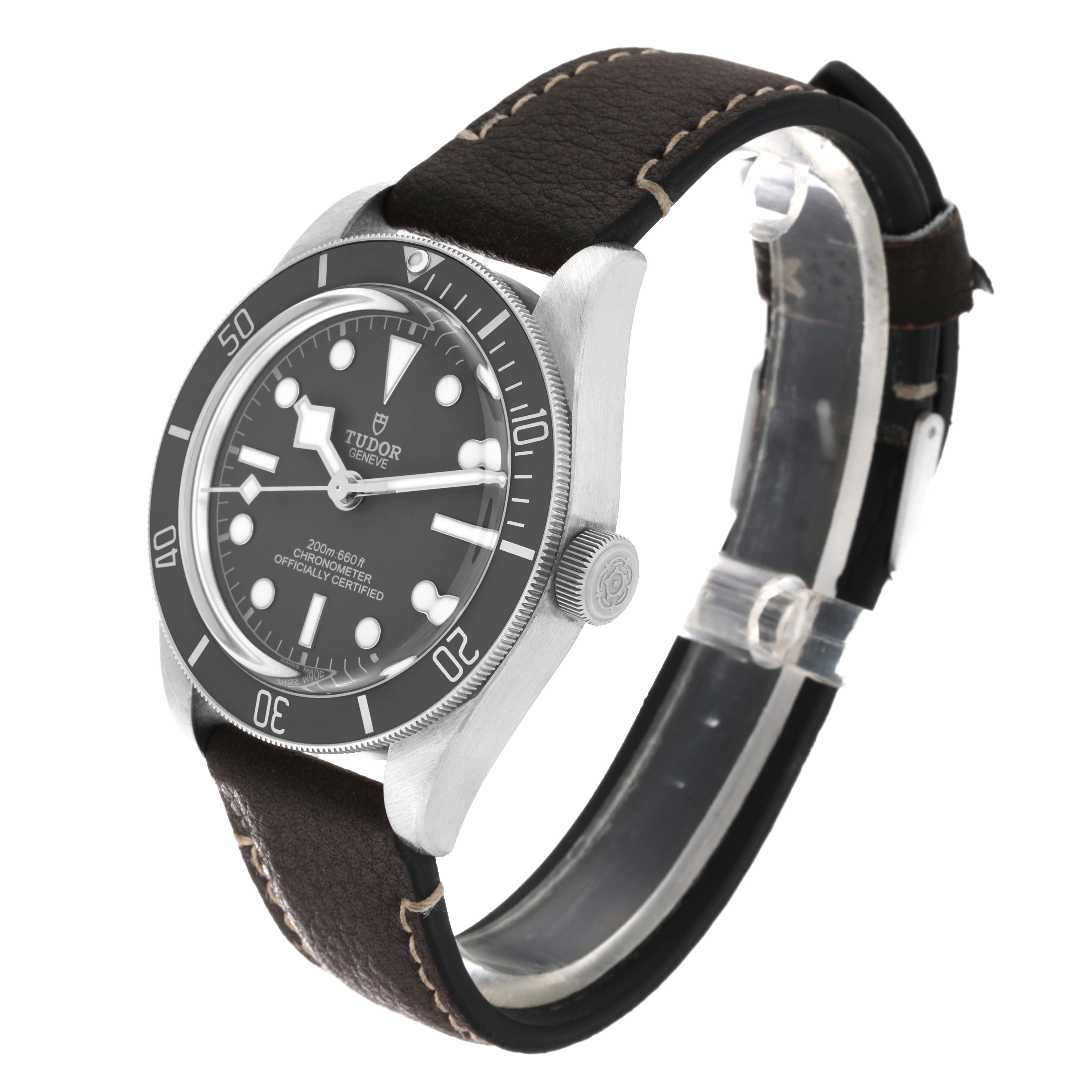 The Tudor Heritage Black Bay M79010SG-0002 Men's Stainless Steel Grey Dial M79010SG-0002 Men's Stainless Steel Grey Dial watch is shown at an angled side view, highlighting its face, bezel, crown, and leather strap.