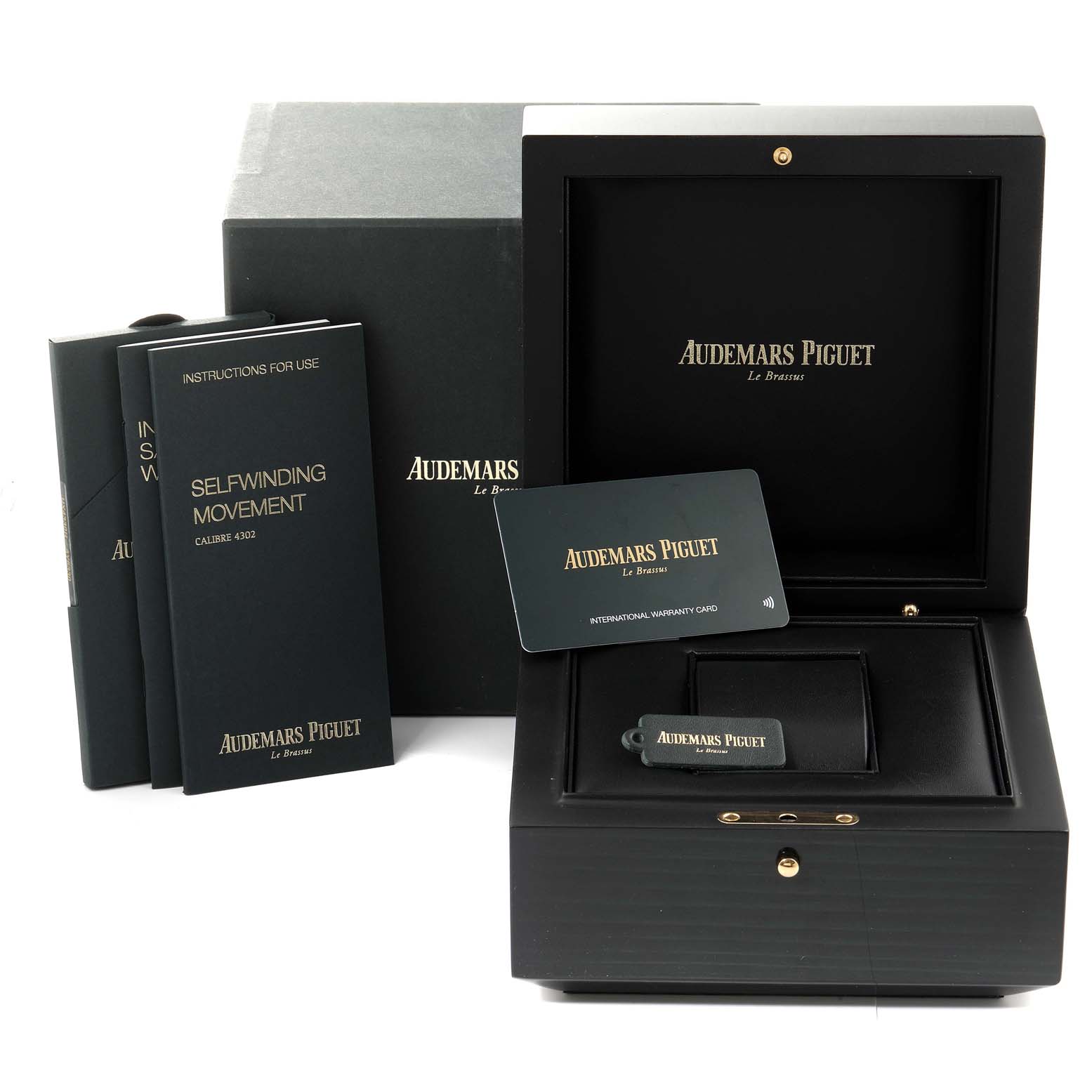 The image shows the packaging and accessories for the Audemars Piguet Royal Oak 15500ST.OO.1220ST.04 Men's Stainless Steel Silver Dial 15500ST.OO.1220ST.04 Men's Stainless Steel Silver Dial, including the watch box, instruction booklets, and warranty card.