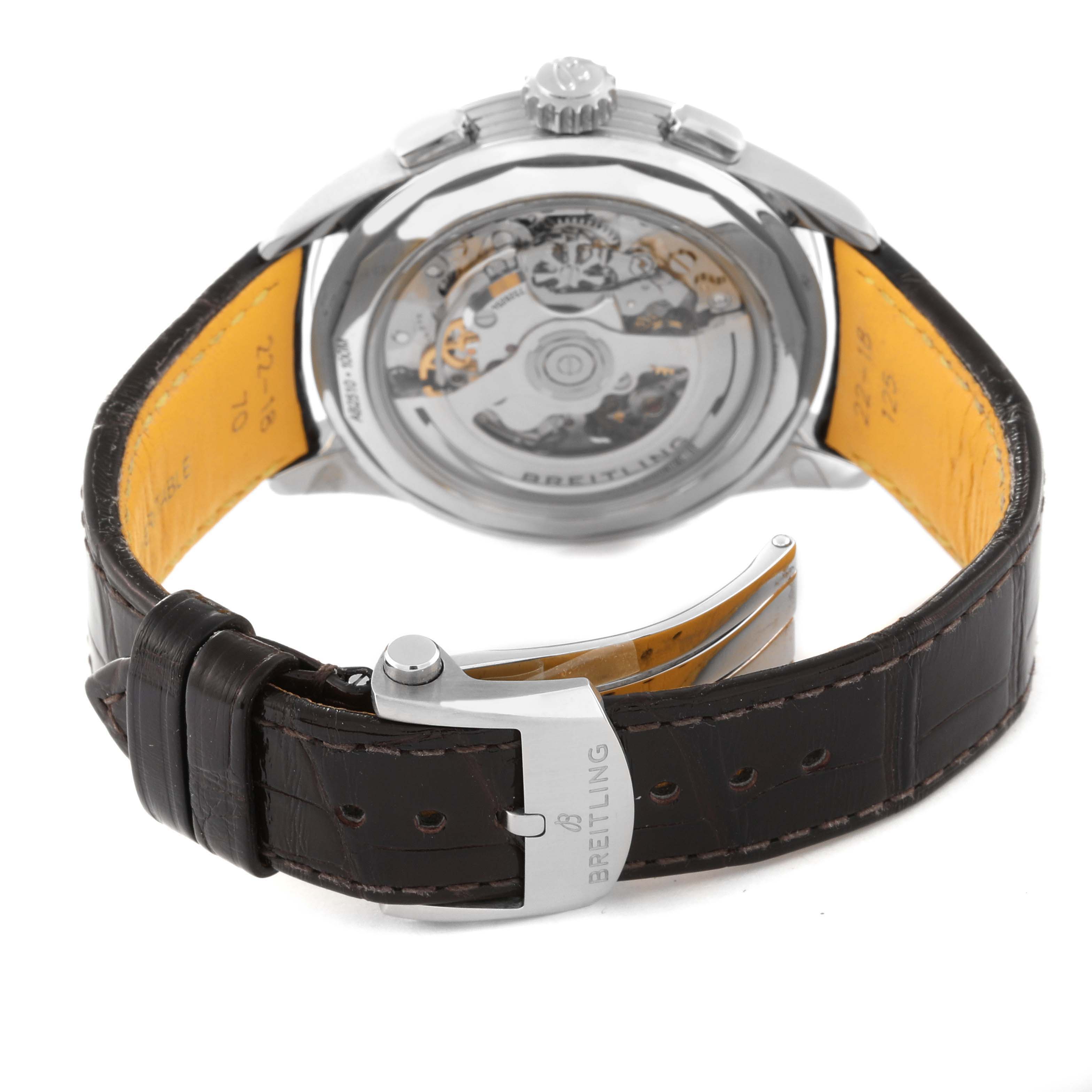 The Breitling Premier AB2510201K1P1 Men's Stainless Steel Pink Dial AB2510201K1P1 Men's Stainless Steel Pink Dial watch is shown from the rear, highlighting its open case back and the leather strap clasp.