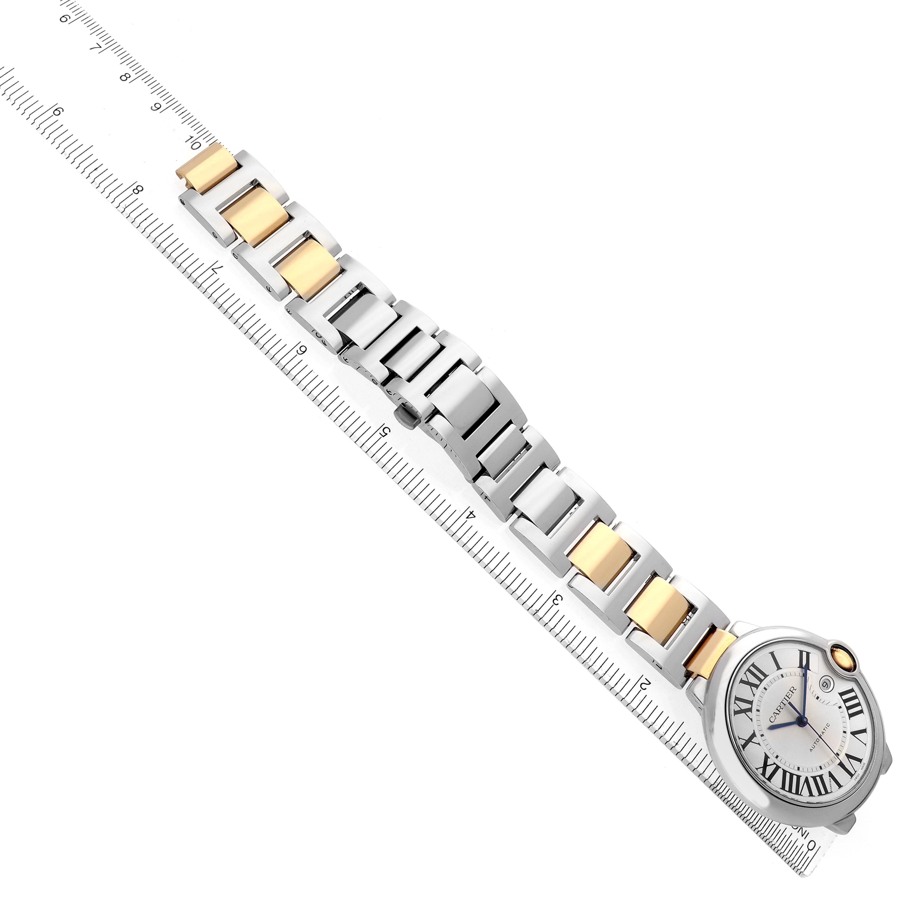 The image shows the Ballon Bleu by Cartier from a top angle, displaying its face and two-tone bracelet alongside a ruler.