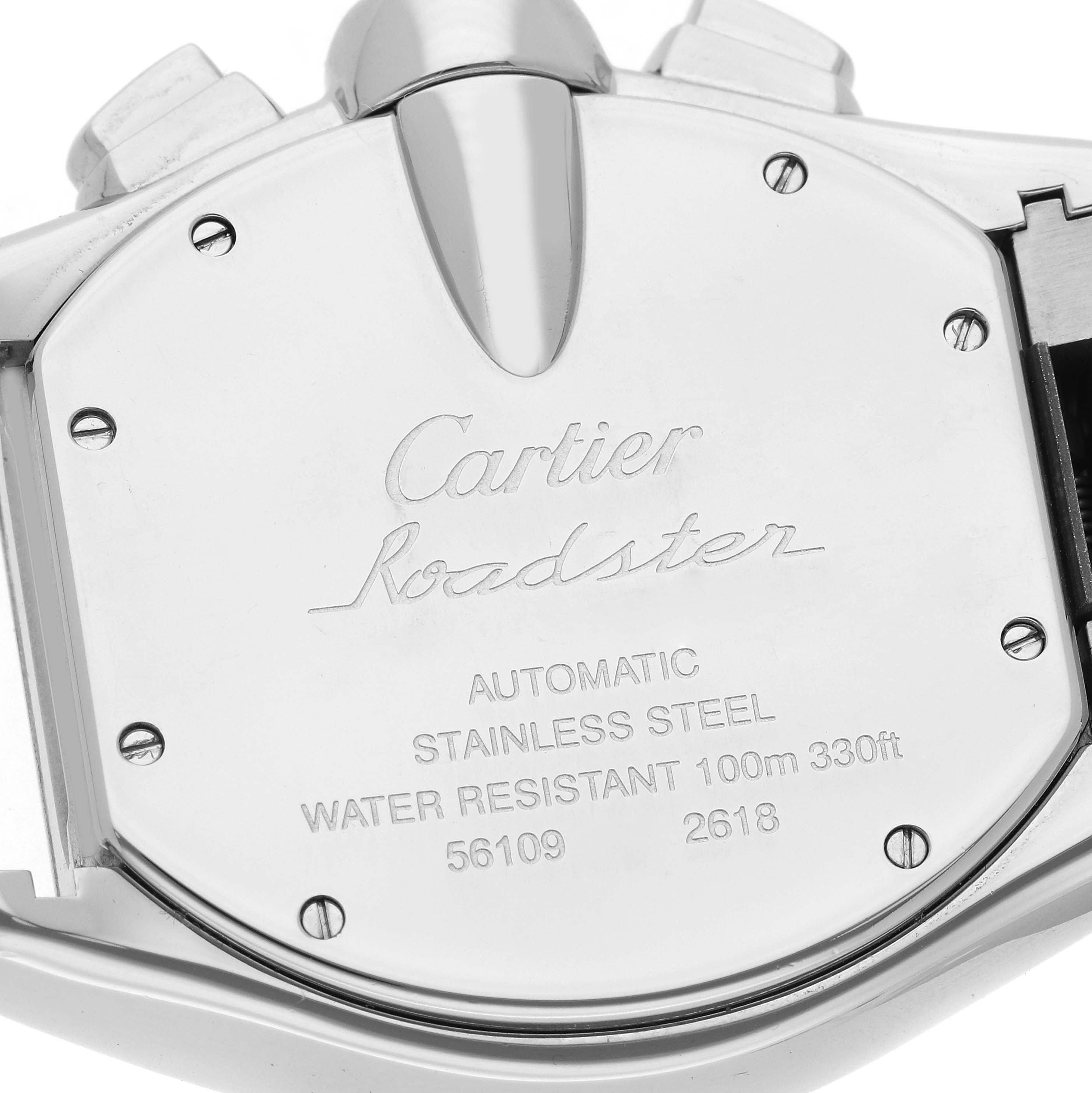 The image shows the back case of a Cartier Roadster W62019X6 Men
s Stainless Steel Silver Dial W62019X6 Men
s Stainless Steel Silver Dial watch, displaying engravings and screws in stainless steel.