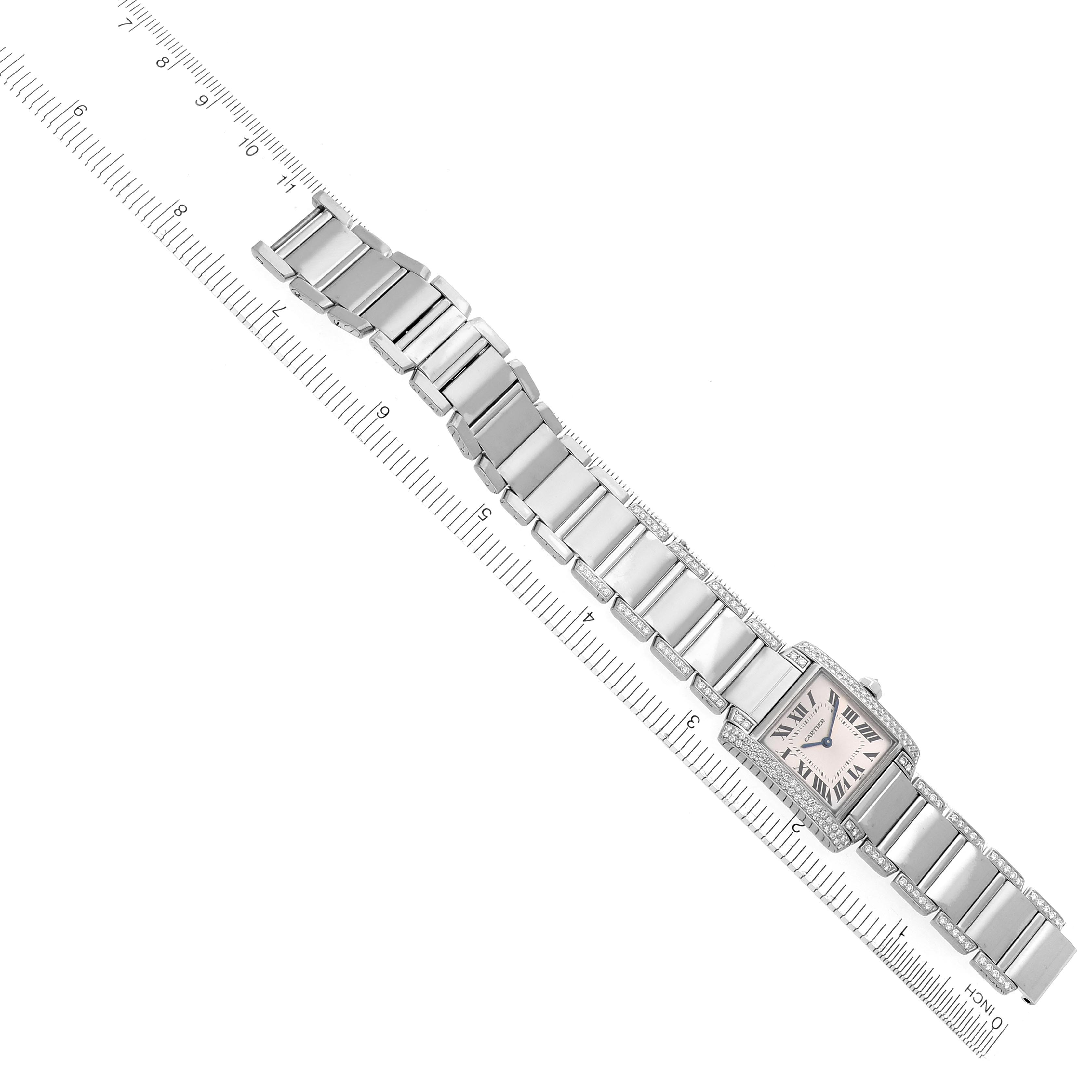 The Cartier Tank Française watch is shown from an overhead angle, highlighting the bracelet and rectangular face.