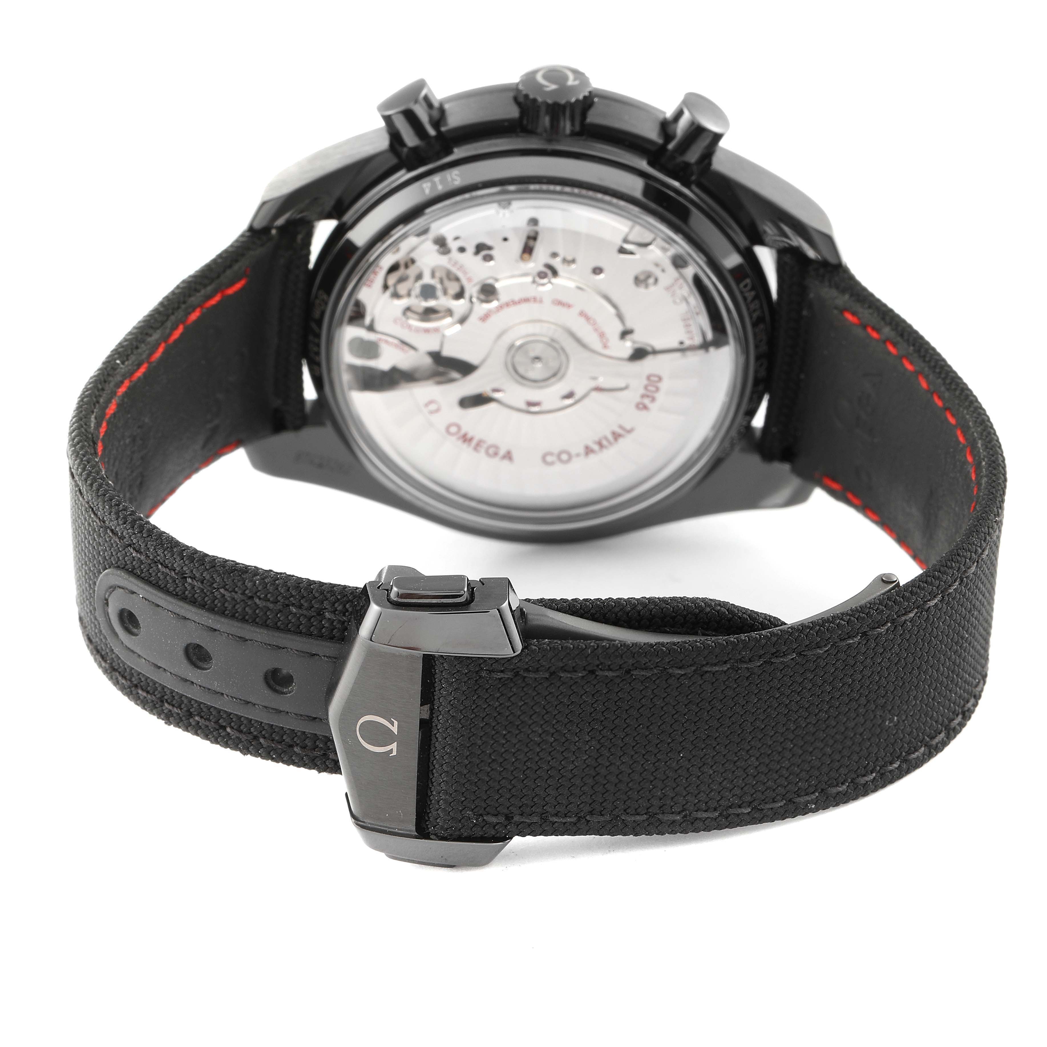 The image shows the back view of an Omega Speedmaster 311.92.44.51.01.007 Men's Ceramic Black Dial 311.92.44.51.01.007 Men's Ceramic Black Dial watch, highlighting the transparent case back and black strap with red stitching.
