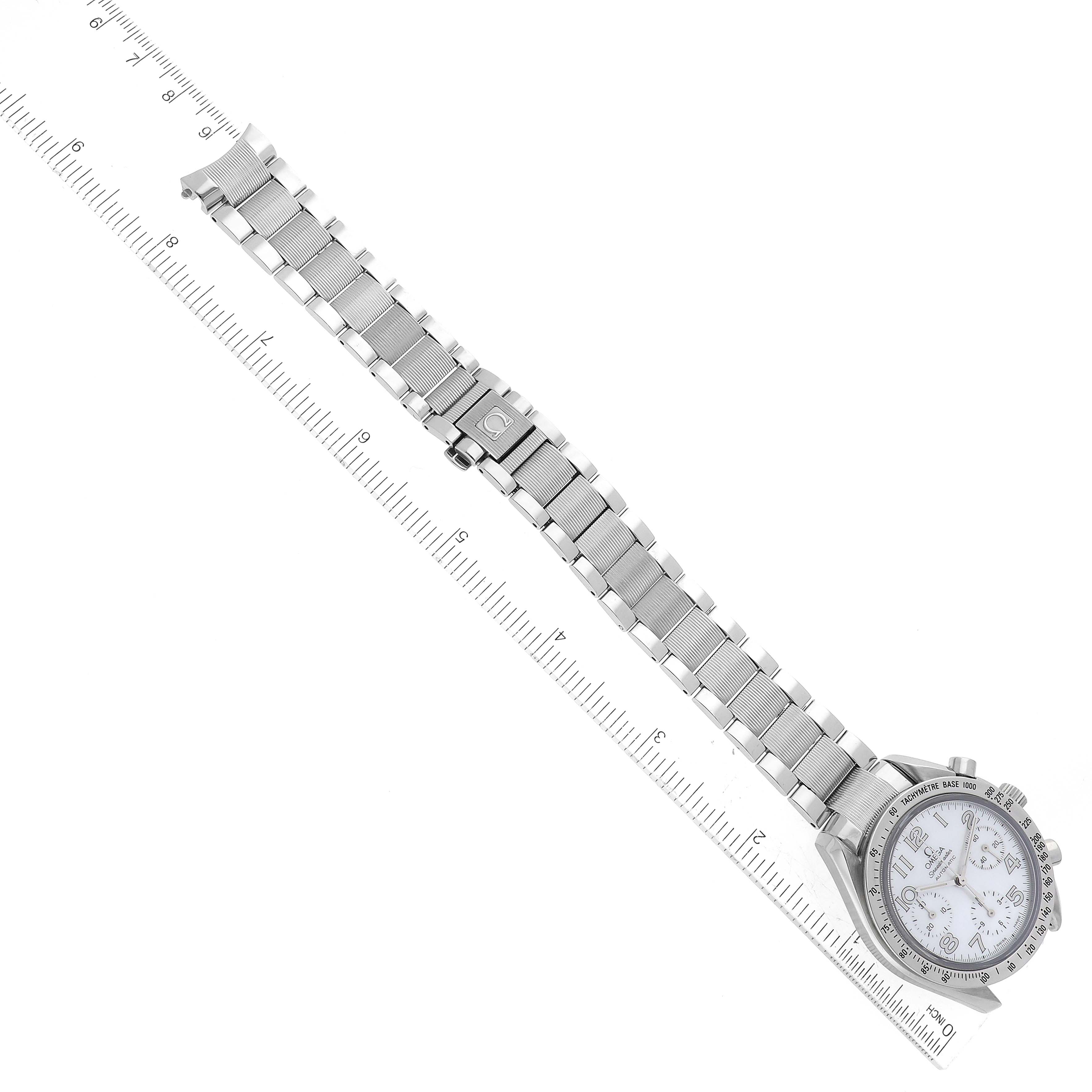 The image shows an overhead view of an Omega Speedmaster 3534.70.00 Men's Stainless Steel Mother of Pearl Dial 3534.70.00 Men's Stainless Steel Mother of Pearl Dial watch, highlighting its entire stainless steel bracelet laid next to a ruler.