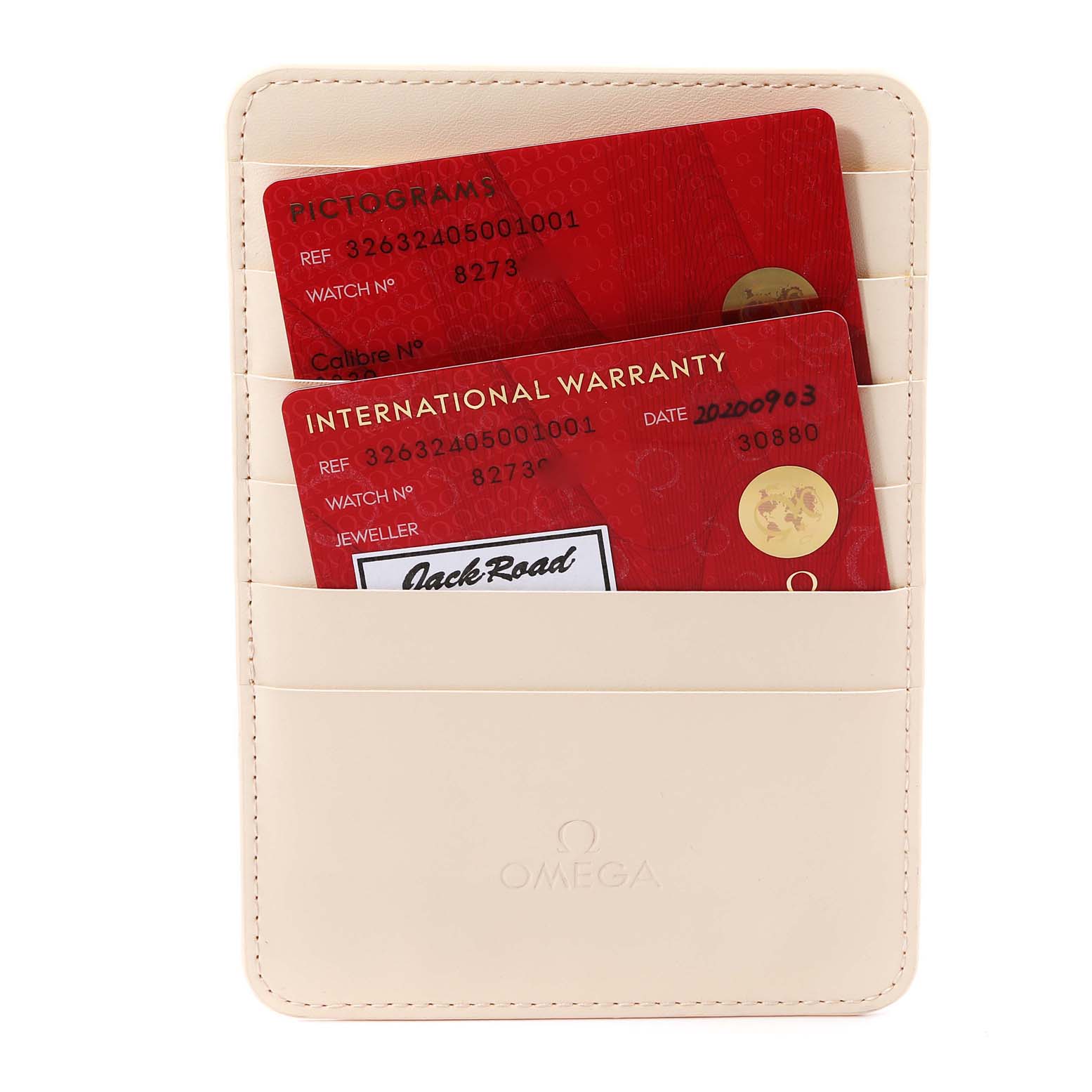 The image shows a beige Omega card holder containing the Pictograms and International Warranty cards for an Omega Speedmaster 326.32.40.50.01.001 Men
s Stainless Steel Black Dial 326.32.40.50.01.001 Men
s Stainless Steel Black Dial watch.