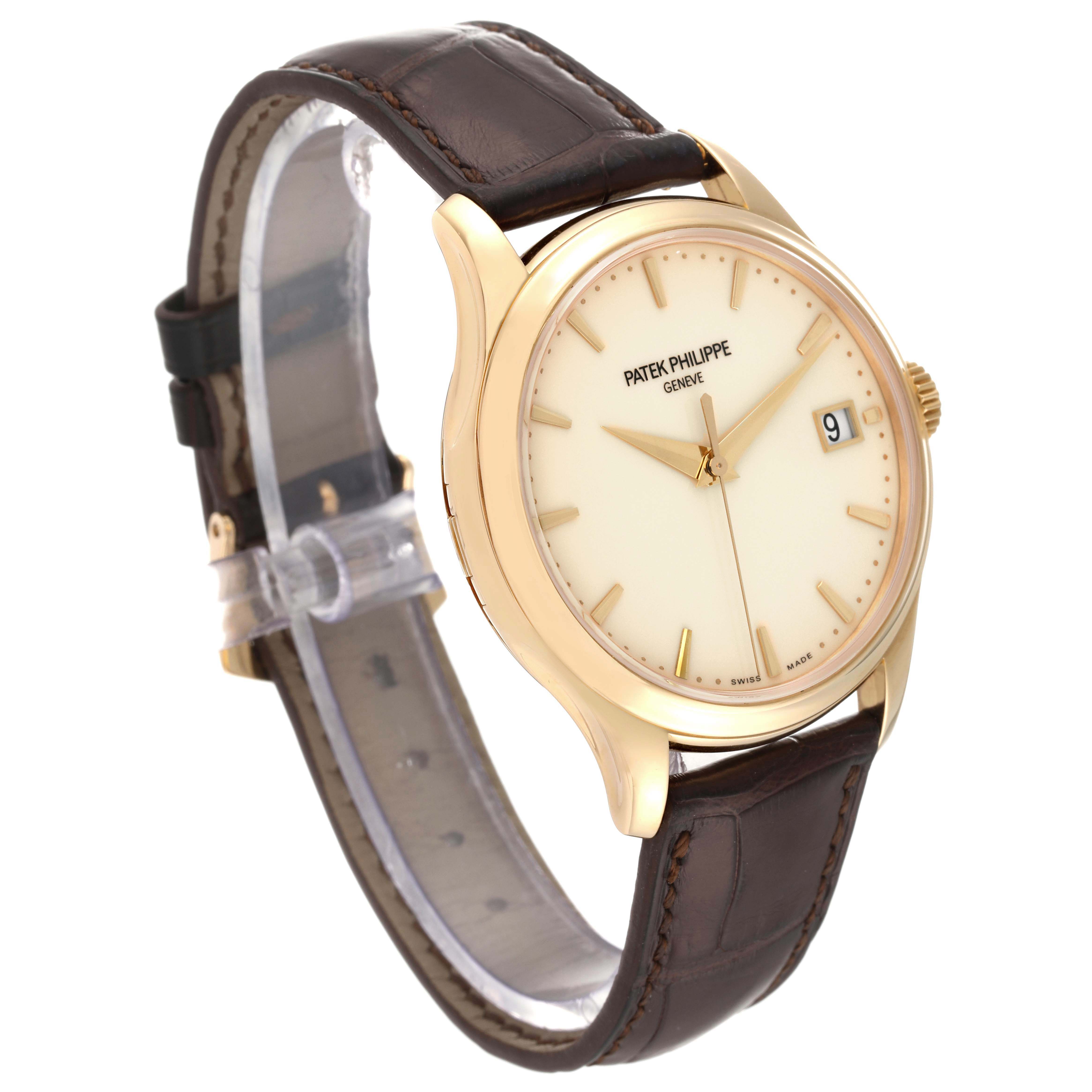 The image shows a Patek Philippe Calatrava 5227J-001 Men's Yellow Gold Beige Dial 5227J-001 Men's Yellow Gold Beige Dial watch angled from the front with a visible dial, case, and brown leather strap.