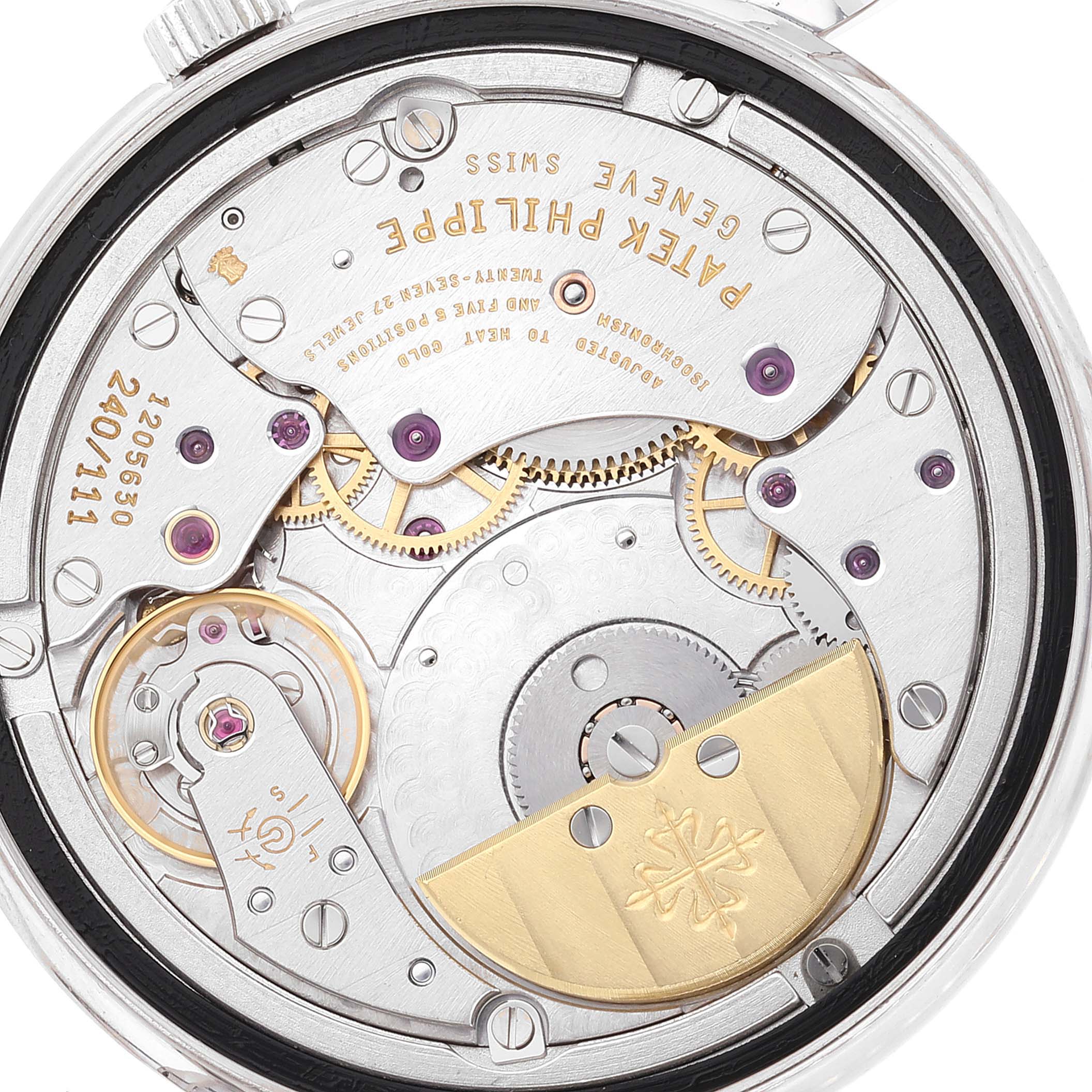The image shows the intricate back view of the movement and inner mechanics of a Patek Philippe Calatrava 5120G Men
s White Gold White Dial 5120G Men
s White Gold White Dial watch.