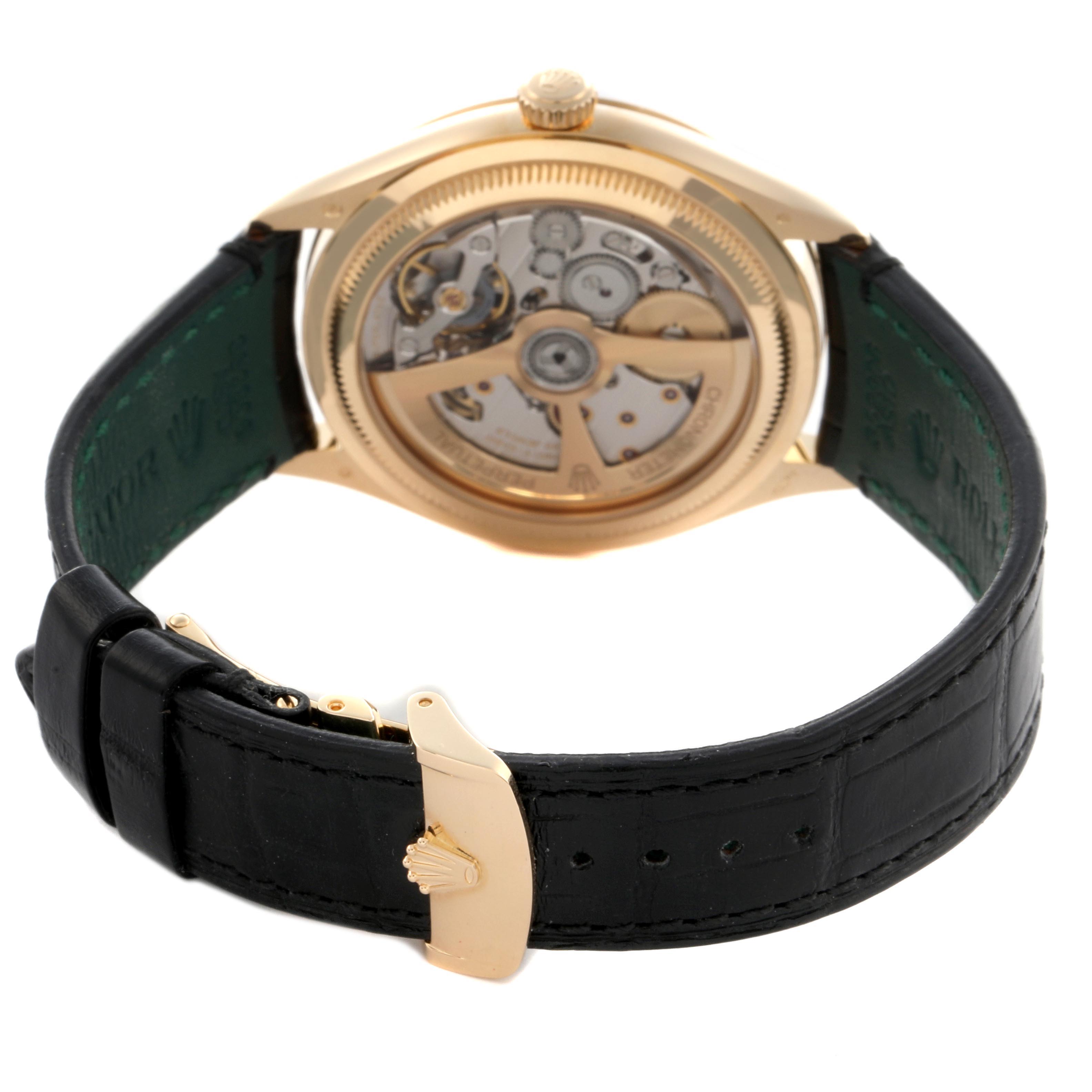 The image shows the back view of a Rolex 1908 52508-0002 Men
s Yellow Gold Black Dial 52508-0002 Men
s Yellow Gold Black Dial model, highlighting its open case back and movement, with a glimpse of the black leather strap and gold buckle.