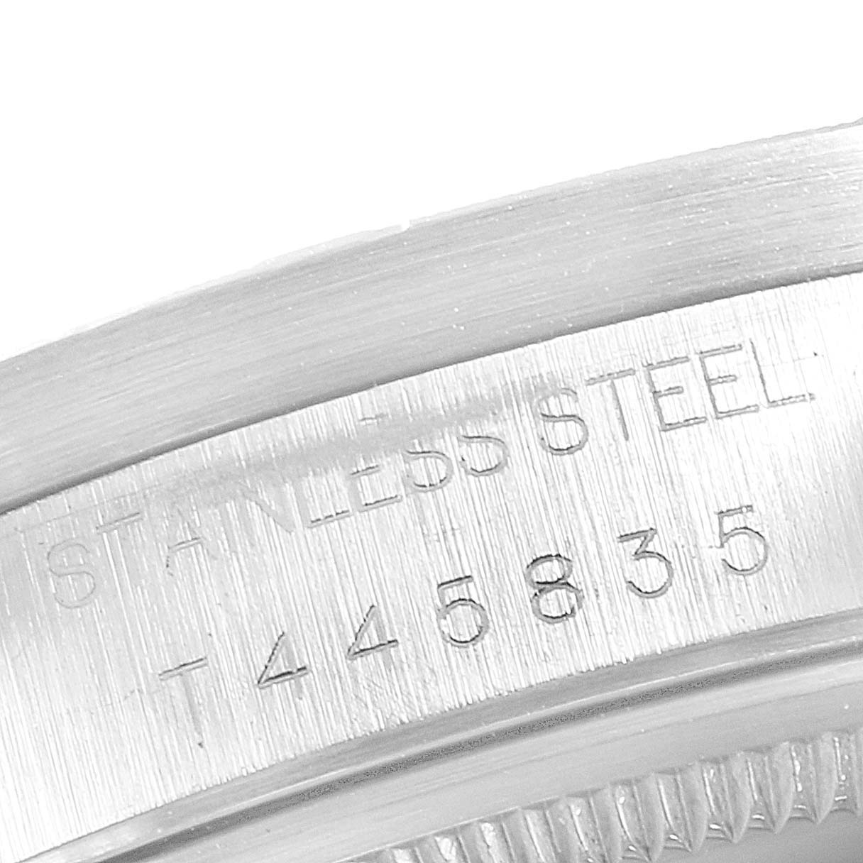 This image shows a close-up of the engraved serial number on the stainless steel case of a Rolex Air-King 14010 Men's Stainless Steel Blue Dial 14010 Men's Stainless Steel Blue Dial watch.