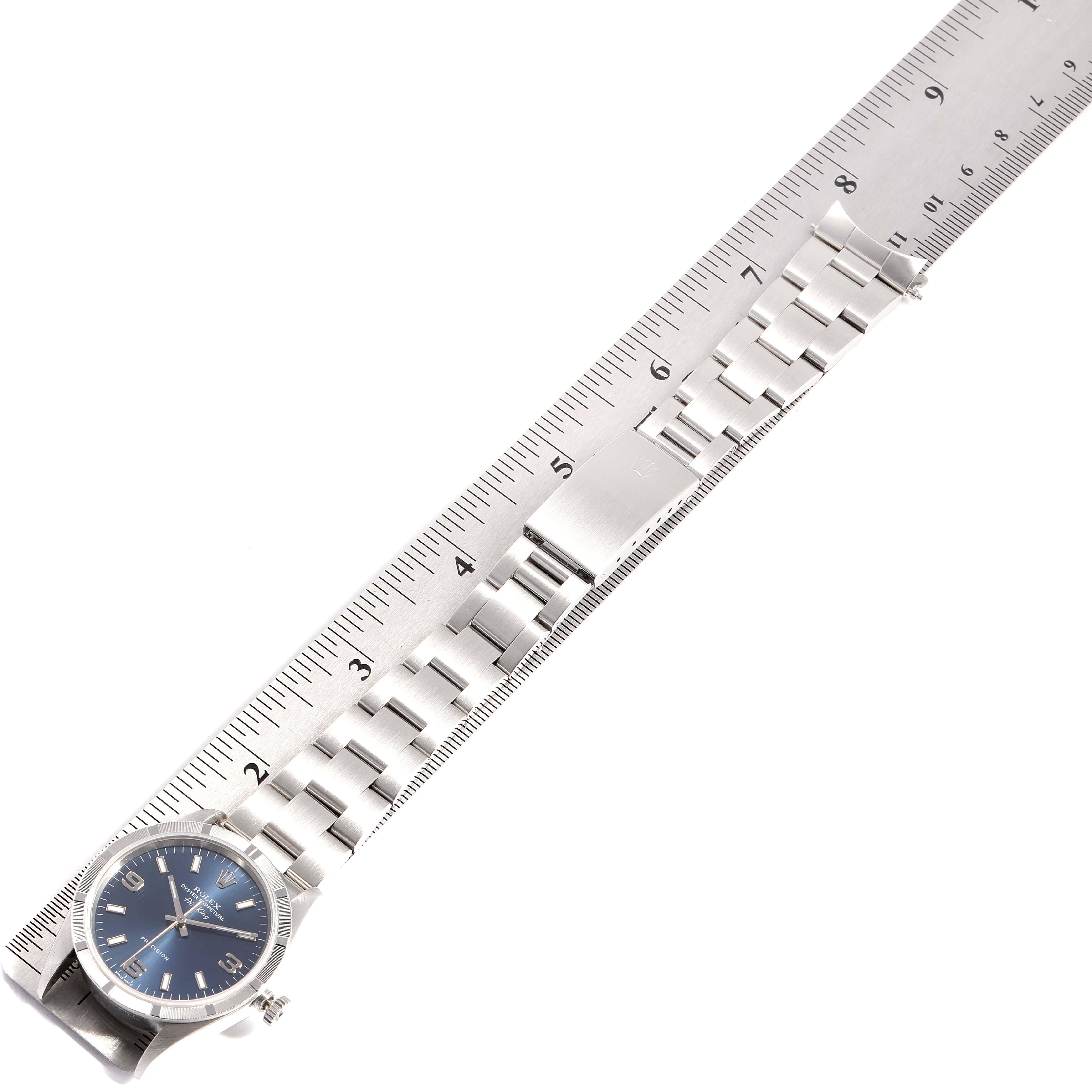 The image shows a Rolex Air-King 14010 Men's Stainless Steel Blue Dial 14010 Men's Stainless Steel Blue Dial watch laid flat next to a ruler, highlighting its bracelet and clasp.