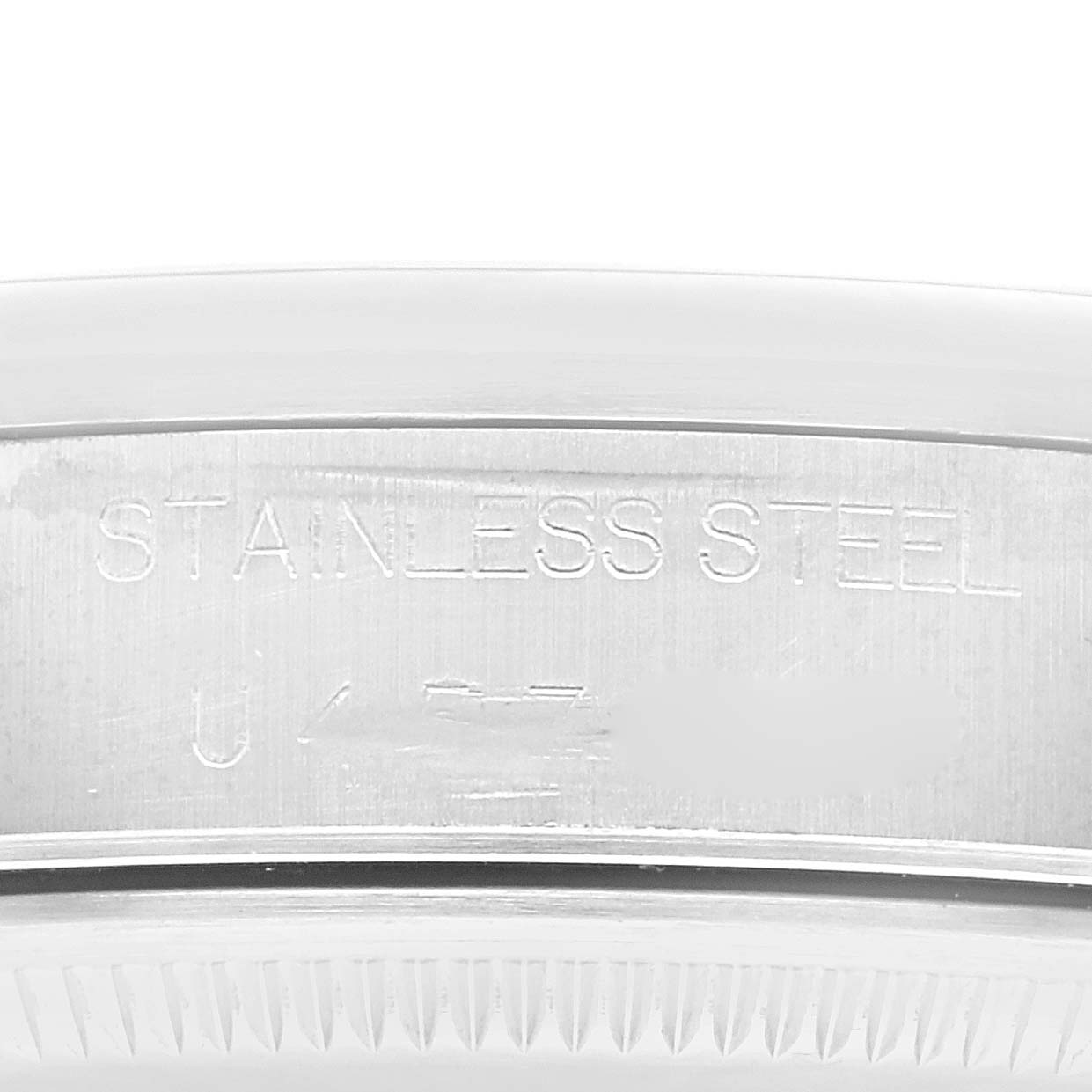 This image shows a close-up of the engraved stainless steel case back of a Rolex Air-King 14000 Men's Stainless Steel Pink Dial 14000 Men's Stainless Steel Pink Dial watch.