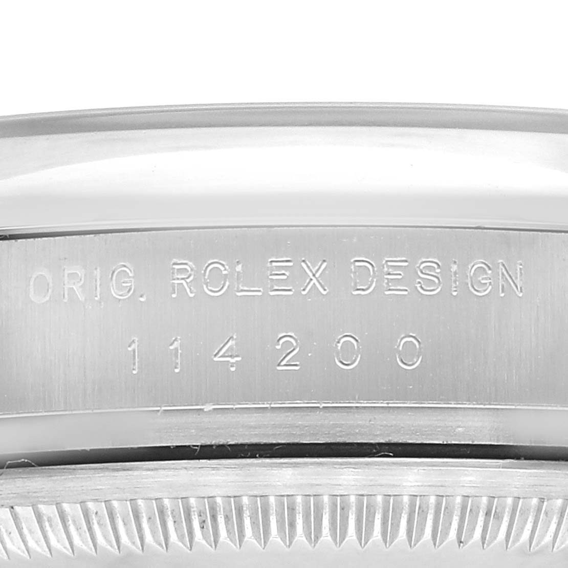 This image shows an up-close view of the engraved case side of a Rolex Air-King 114200 Men's Stainless Steel Silver Dial 114200 Men's Stainless Steel Silver Dial watch, displaying its model number and "ORIG. ROLEX DESIGN."