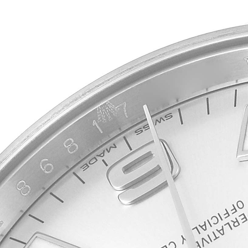 This close-up image of the Rolex Air-King 114200 Men's Stainless Steel Silver Dial 114200 Men's Stainless Steel Silver Dial watch shows a partial view of the dial, including numerals and the minute hand.