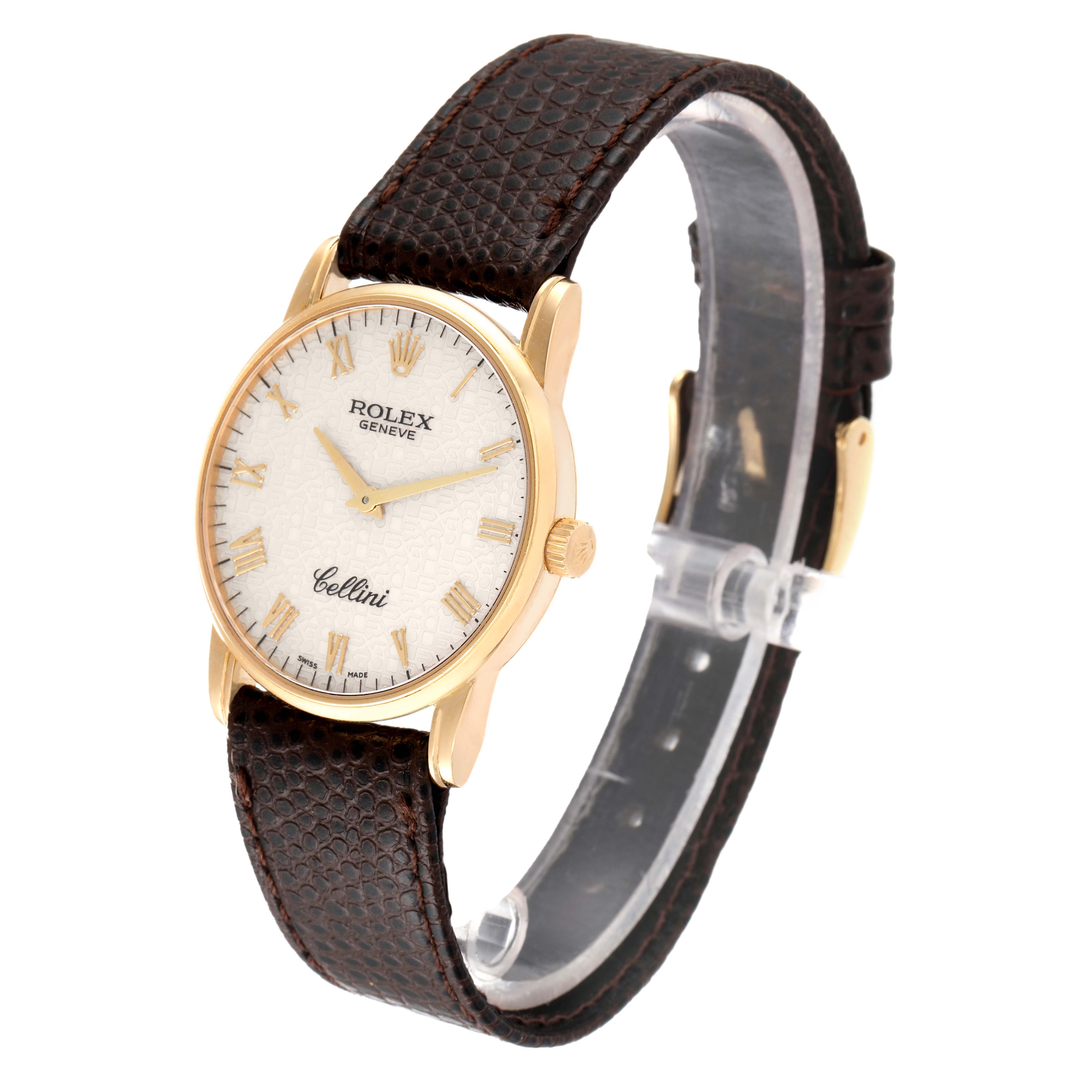 The Rolex Cellini 5116 Men's Yellow Gold Beige Dial 5116 Men's Yellow Gold Beige Dial watch is shown at a slight angle, displaying the face, case, and part of the leather strap.