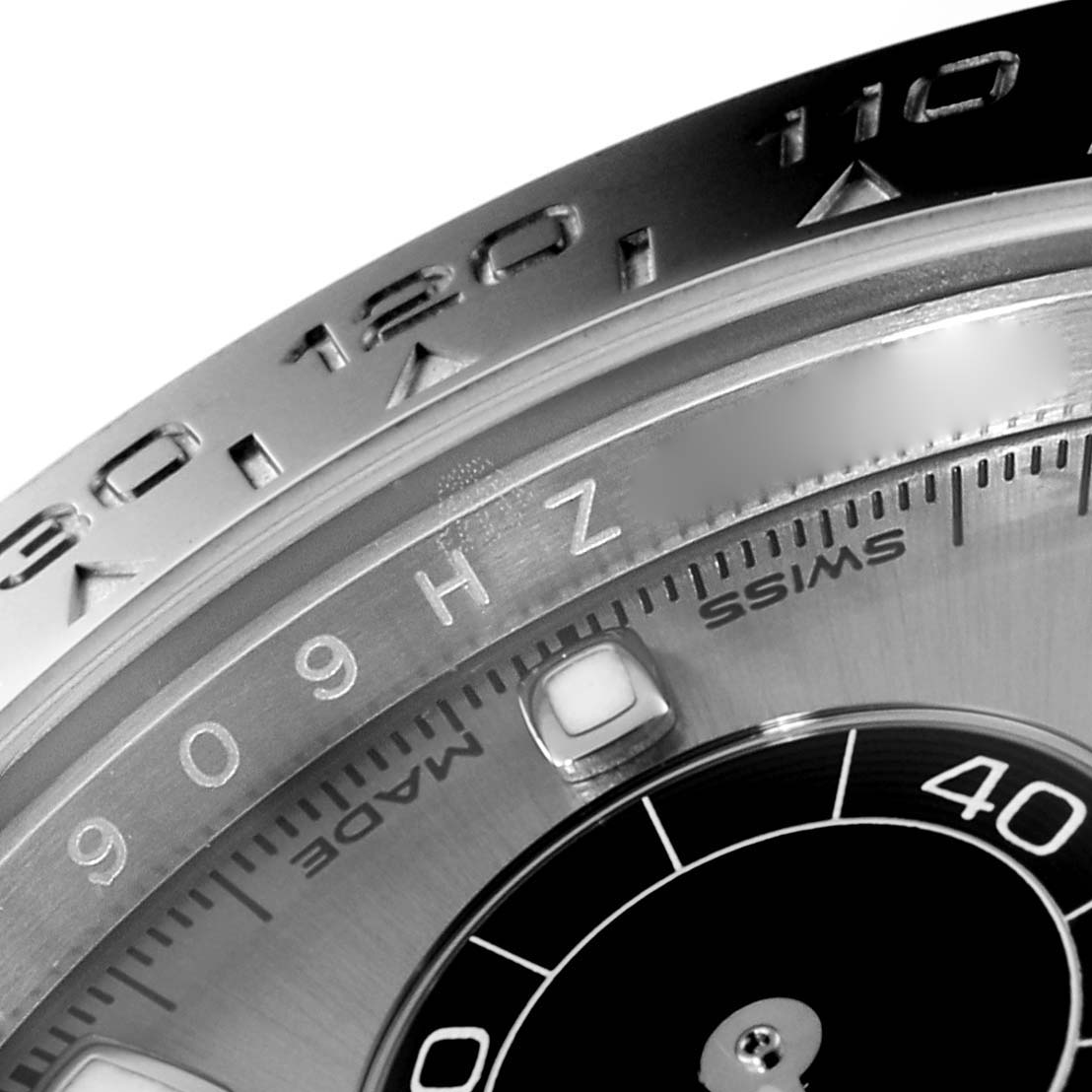 The image shows a close-up angle of the bezel and dial of a Rolex Daytona 116519 Men's White Gold Grey Dial 116519 Men's White Gold Grey Dial watch, highlighting the tachymeter scale and part of the sub-dial.