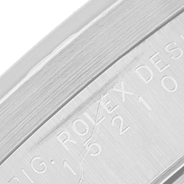 This image shows a close-up of the inside edge of the case of a Rolex Date 15210 Men's Stainless Steel Black Dial 15210 Men's Stainless Steel Black Dial model watch with visible engravings.