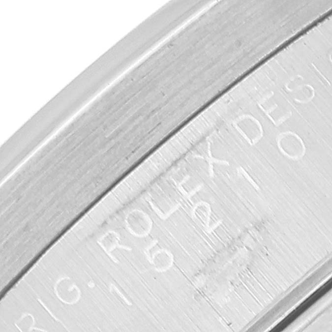 This close-up image shows the engraved inner case of a Rolex Date 15210 Men's Stainless Steel Blue Dial 15210 Men's Stainless Steel Blue Dial model.