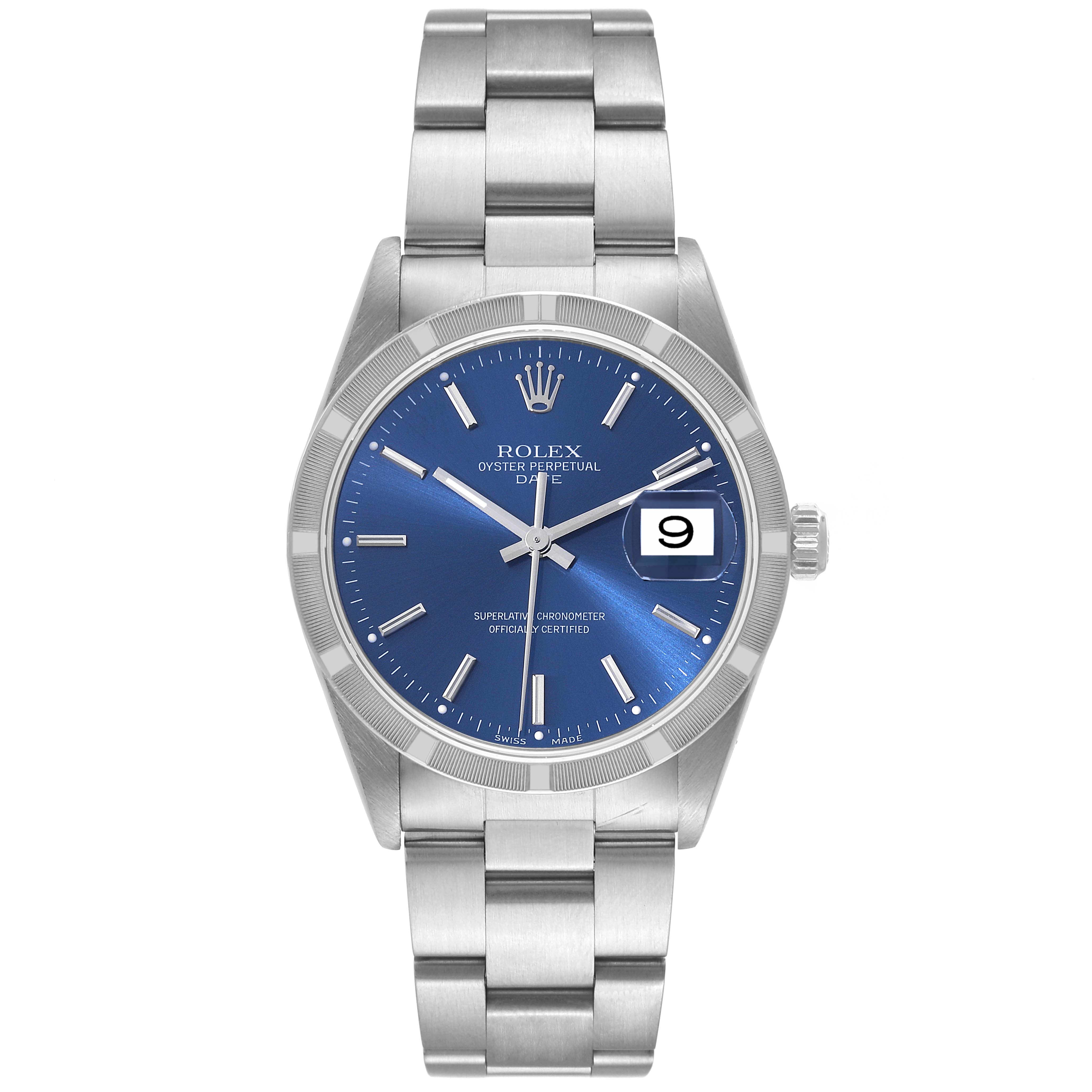 The image shows a Rolex Oyster Perpetual Date model watch, captured from a front-facing angle showcasing the blue dial, bezel, and bracelet.