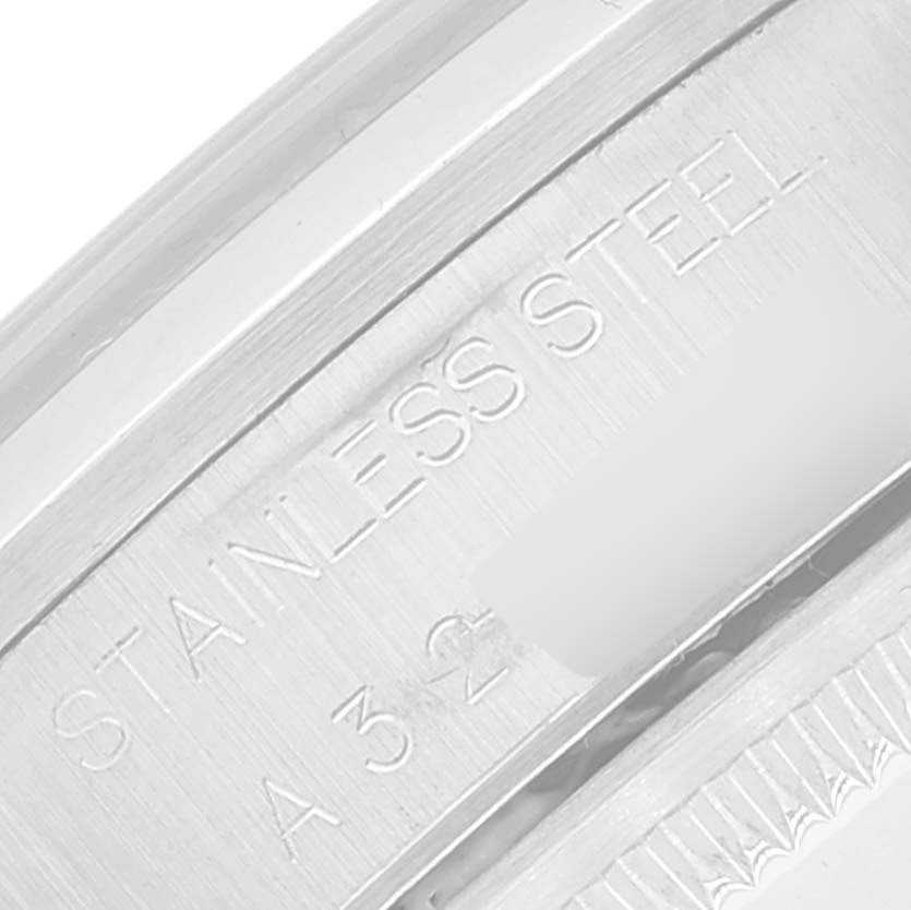 This close-up image shows the stainless steel part of a Rolex Date 15200 Men's Stainless Steel Blue Dial 15200 Men's Stainless Steel Blue Dial model watch with engraved markings.