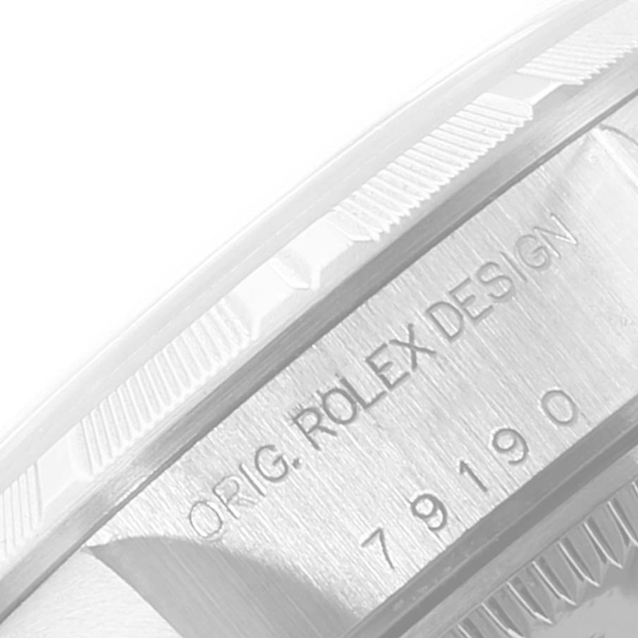 This image shows a close-up of the case side of the Rolex Date 79190 Women's Stainless Steel White Dial 79190 Women's Stainless Steel White Dial model, displaying the engraving "ORIG. ROLEX DESIGN 79190".