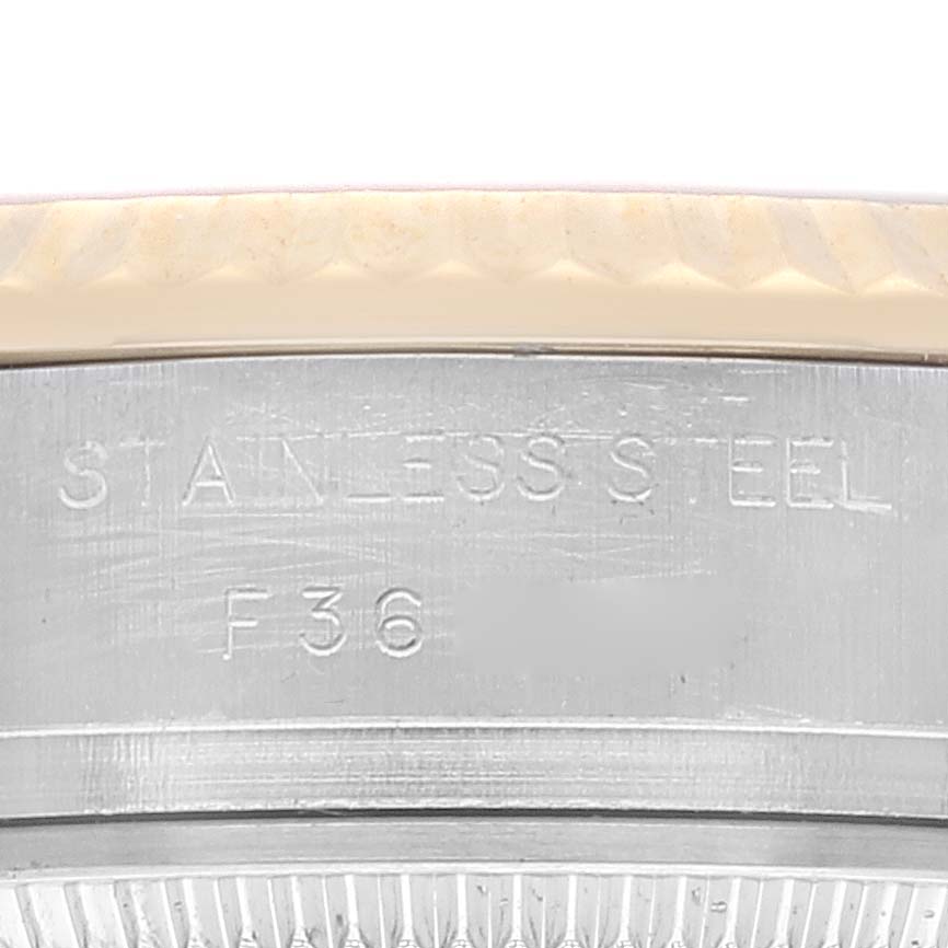 The image shows a close-up of the side with an inscription on the stainless steel case of a Rolex Datejust 179173 Women's Steel and Gold (two tone) Champagne Dial 179173 Women's Steel and Gold (two tone) Champagne Dial watch.