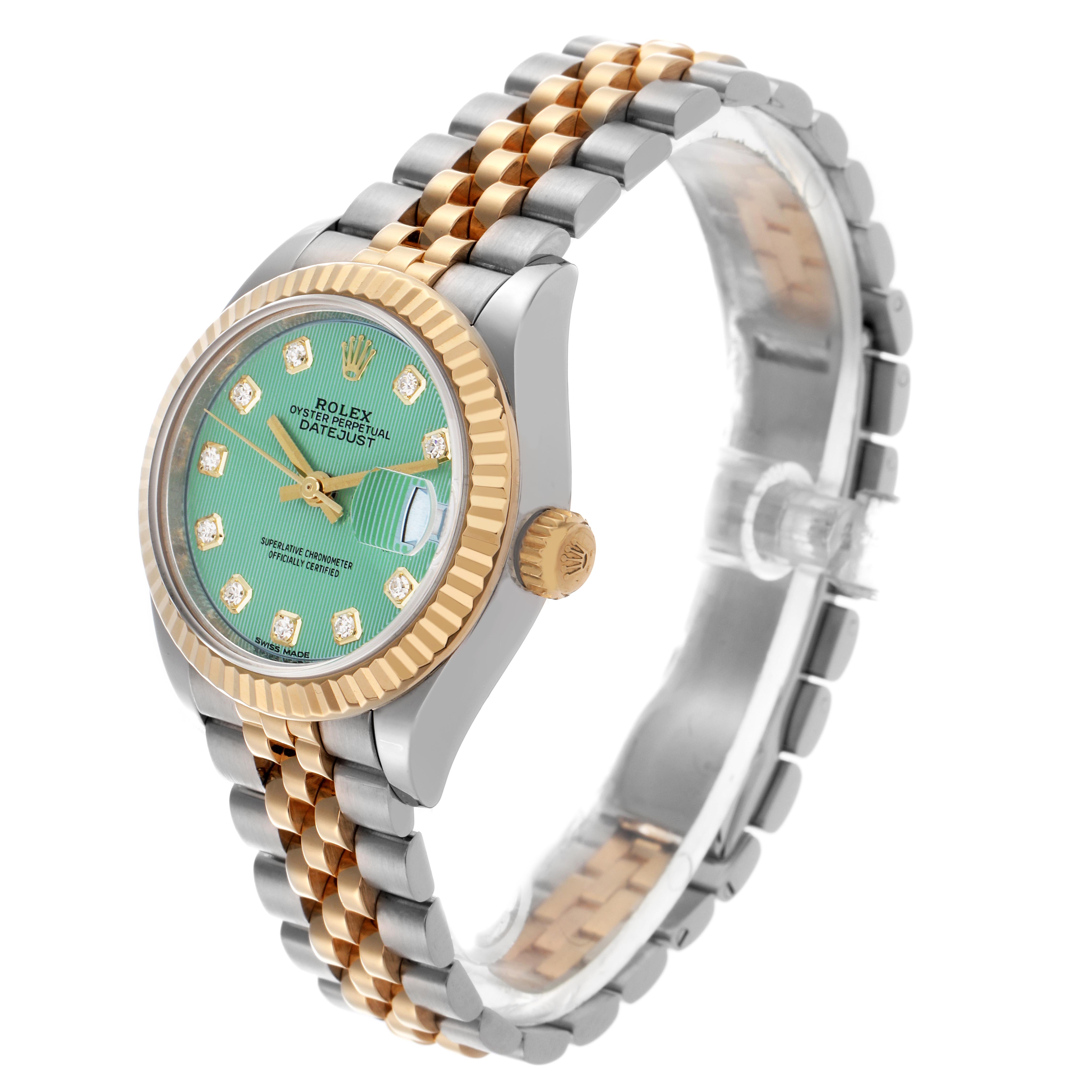 The Rolex Datejust 279173 Women's Steel and Gold (two tone) Green Dial 279173 Women's Steel and Gold (two tone) Green Dial watch is shown at a slight angle, highlighting its gold and silver bracelet, green dial, and diamond hour markers.