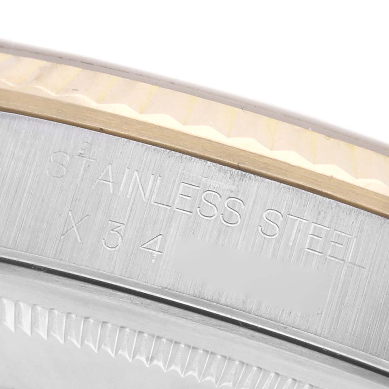 The image shows a close-up of the edge and part of the stainless steel back of a Rolex Datejust 16233 Men
s Steel and Gold (two tone) Champagne Dial 16233 Men
s Steel and Gold (two tone) Champagne Dial watch.