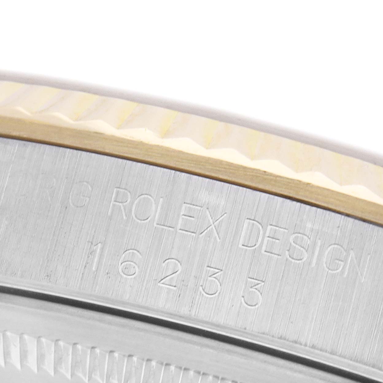 The image shows a close-up of the side of the Rolex Datejust 16233 Men
s Steel and Gold (two tone) Champagne Dial 16233 Men
s Steel and Gold (two tone) Champagne Dial, highlighting the engraved model number and brushed metal finish.