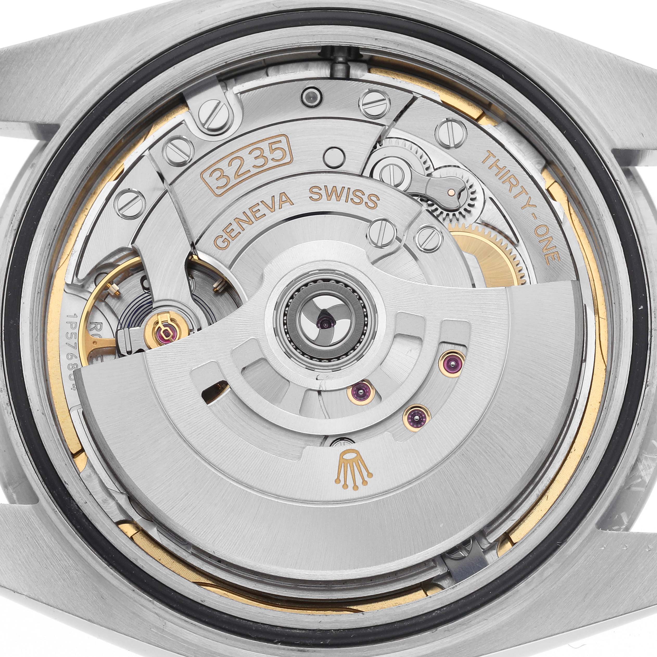 This image shows the Rolex Datejust 41 126300 Men
s Stainless Steel Blue Dial 126300 Men
s Stainless Steel Blue Dial
s intricate movement from the backside, highlighting its automatic rotor and mechanical components.