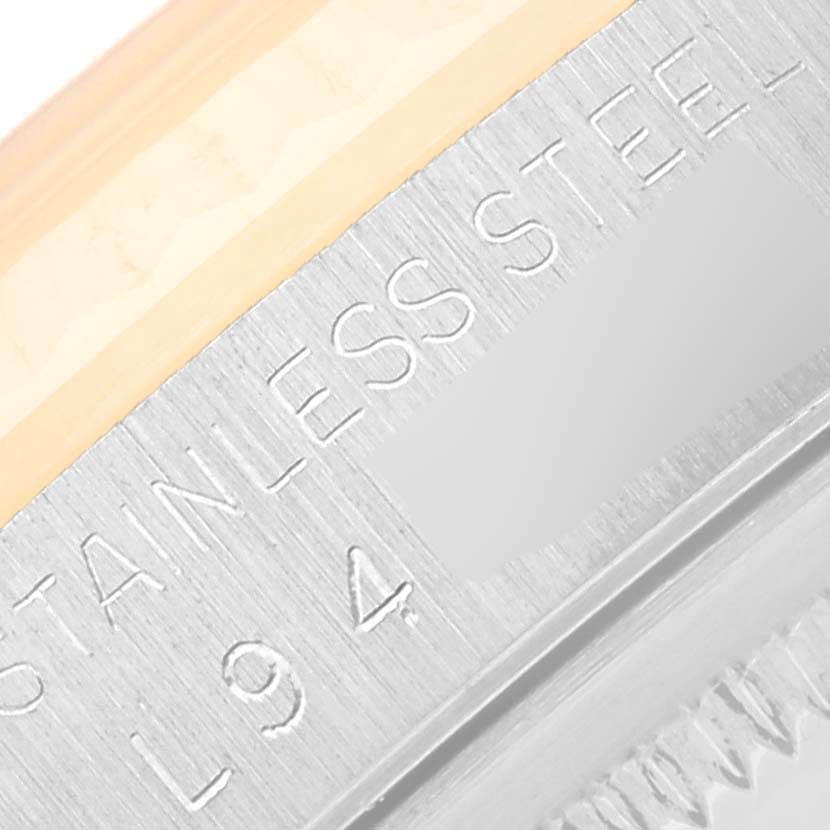 The image shows a close-up of the side of the bezel and case of a Rolex Datejust 16233 Men's Steel and Gold (two tone) Champagne Dial 16233 Men's Steel and Gold (two tone) Champagne Dial watch, focusing on the "STAINLESS STEEL" engraving.